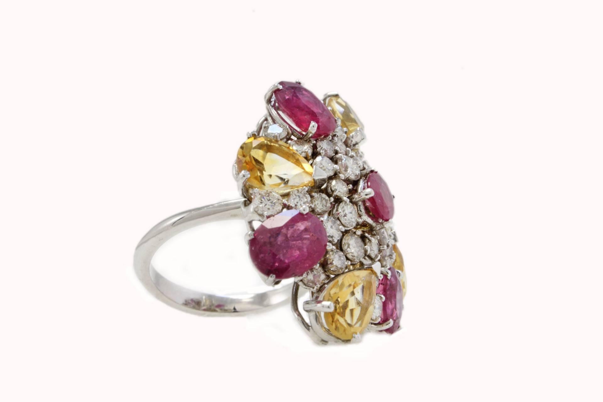 Shiny cocktail ring composed of a flower of citrines alternating with rubies, all around sparkling diamonds. All is mounted in 14 Kt white gold.
Tot Weight 12.35 g
Ring Size : ITA 14 - French 54 - US 6.5 - UK N
Diamonds 2.40 ct
Citrin and rubies