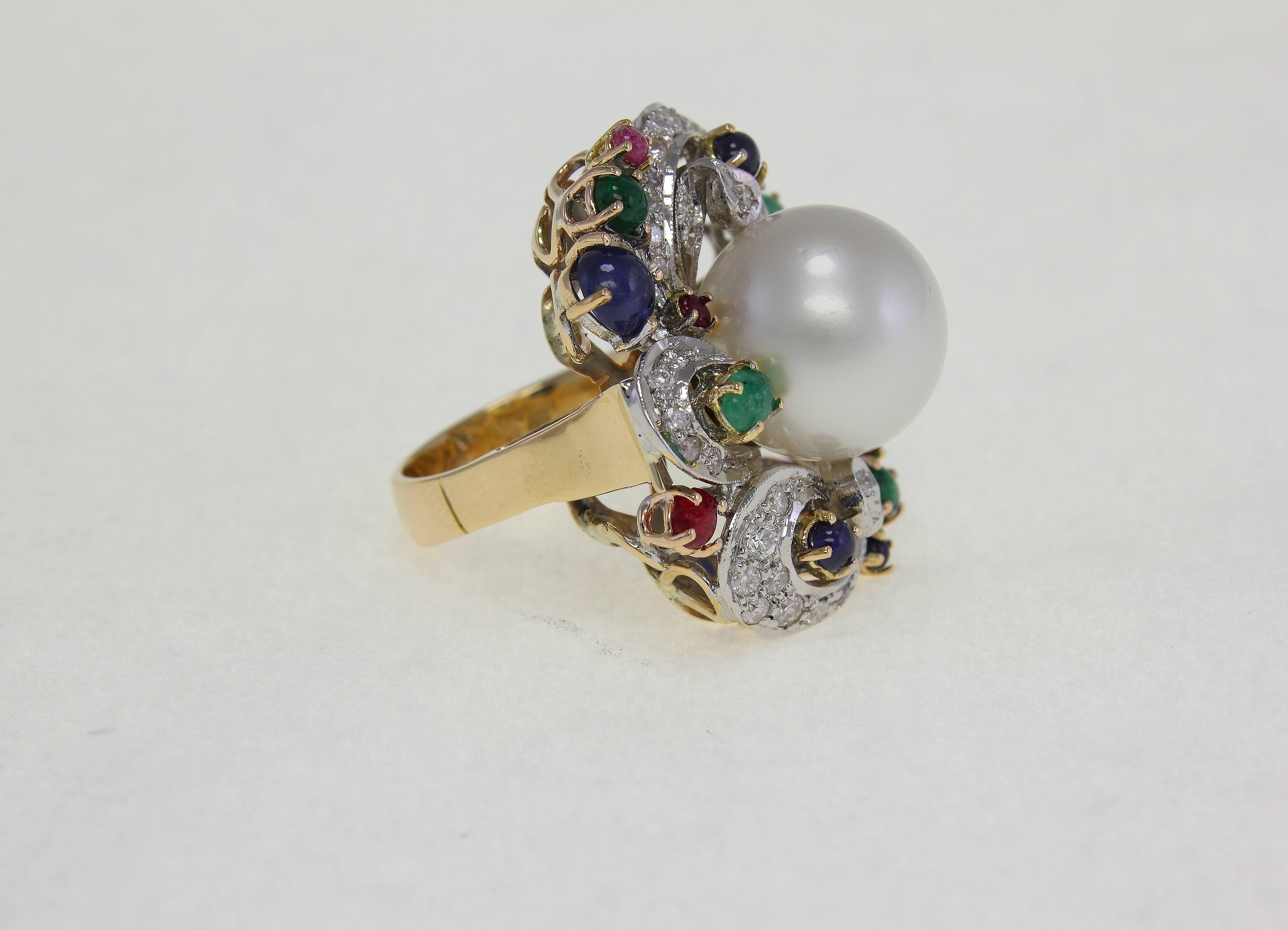  A pearl of 14.5 mm / 0.57 inch diameter in the center of a twist of a pairs of rubies & emeralds divided by single sapphires (total 5.34 carat) & diamonds (0.45 carat). 14 Kt white gold ring
US Size
Width 1.18 inch
Length 1.38 inch
Higth(worn)