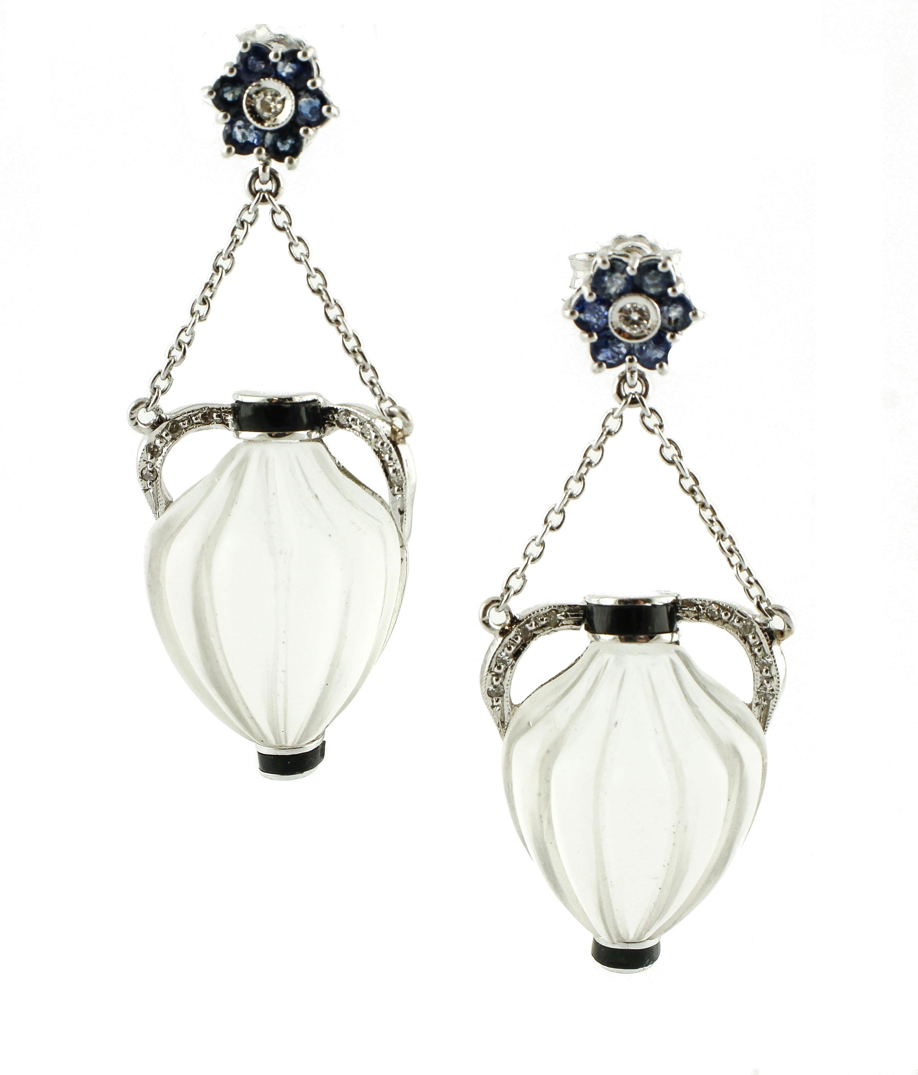 An amphora of crystal rock (6.30 gram / 0.22 f.o.) hang on sapphire (0.84 carat) flowers with diamond spot (0.16 carat). 43 mm / 1.69 inch long.14 Kt white god earrings.
Us Size
Width (anphora) 0.59 inch
Length (earring) 1.69 inch
If you like, you