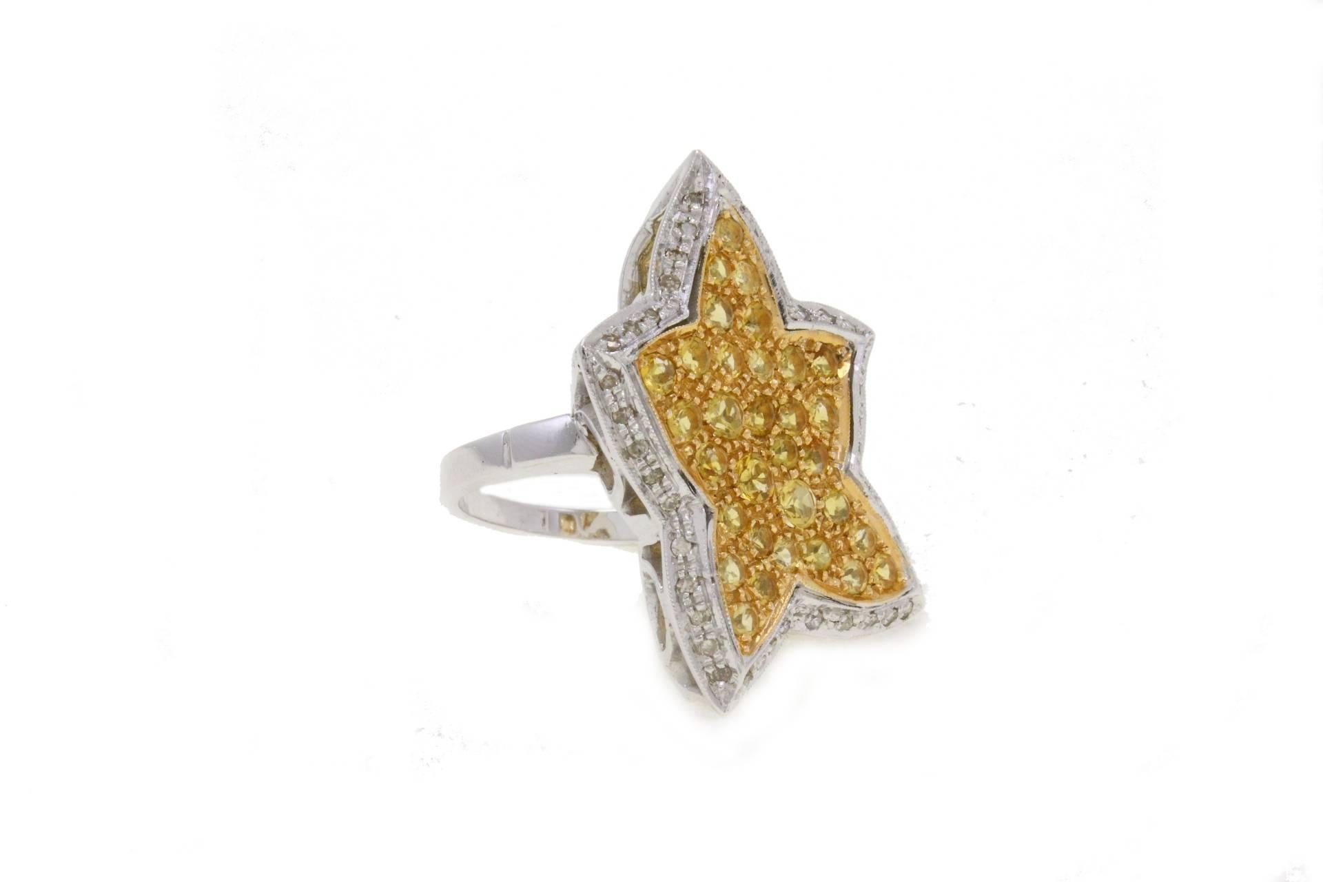 Sparkling star shaped ring in 14kt yellow and white gold covered in topazes and diamonds.

diamonds 0.38kt
topazes 2.48kt
tot weight 13.80gr
Width 0.79 inches
Lenght 1.18 inches
Diameter 0.70  inches
gref gcah