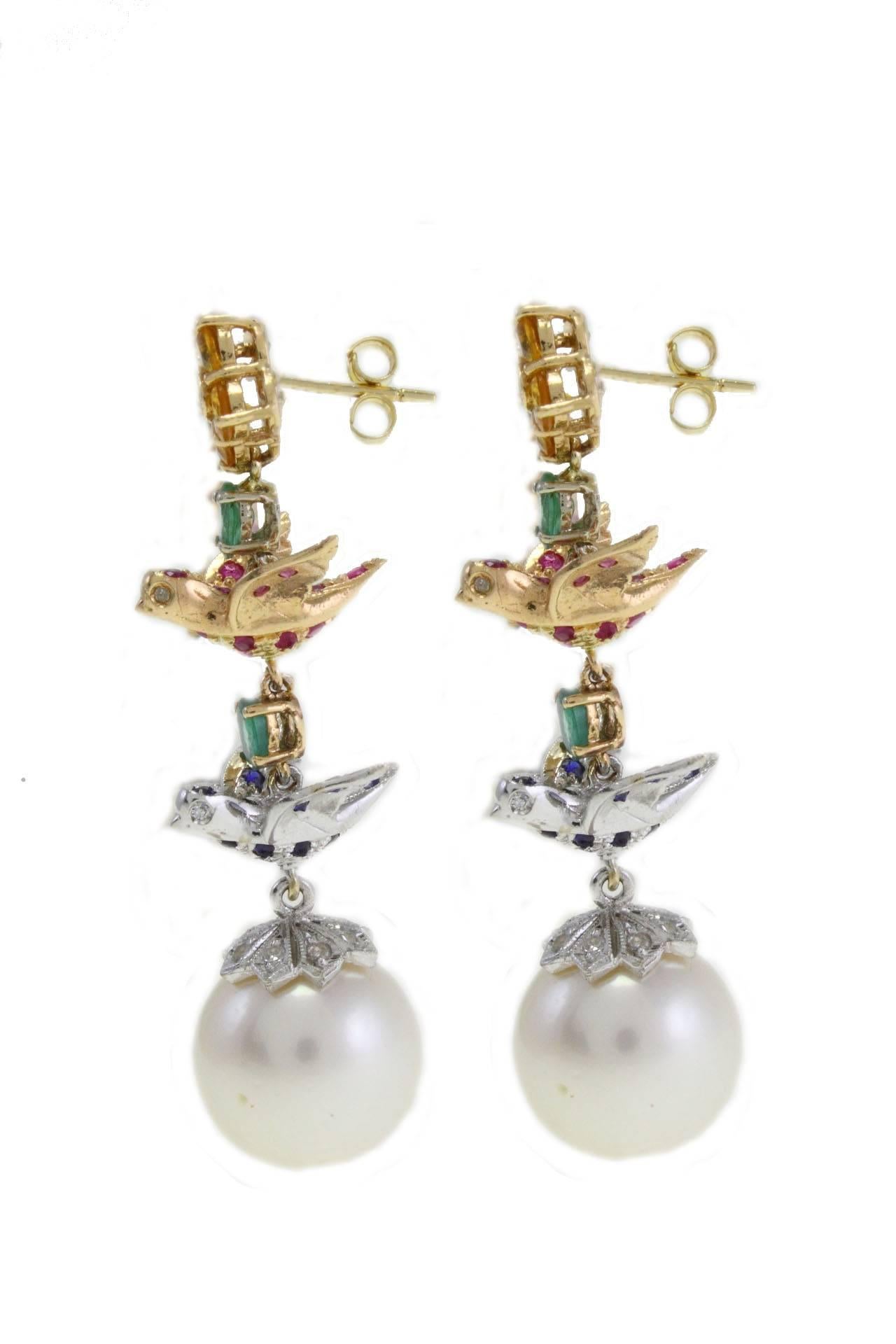 Dangle earrings in 14kt yellow and white gold composed of blue sapphire emeralds linked to a little daisy covered in yellow sapphire on top and a white pearl on the bottom.

diamonds 0.29kt
Sapphire and emerals 2.92kt
Pearl 6.30gr
tot weight