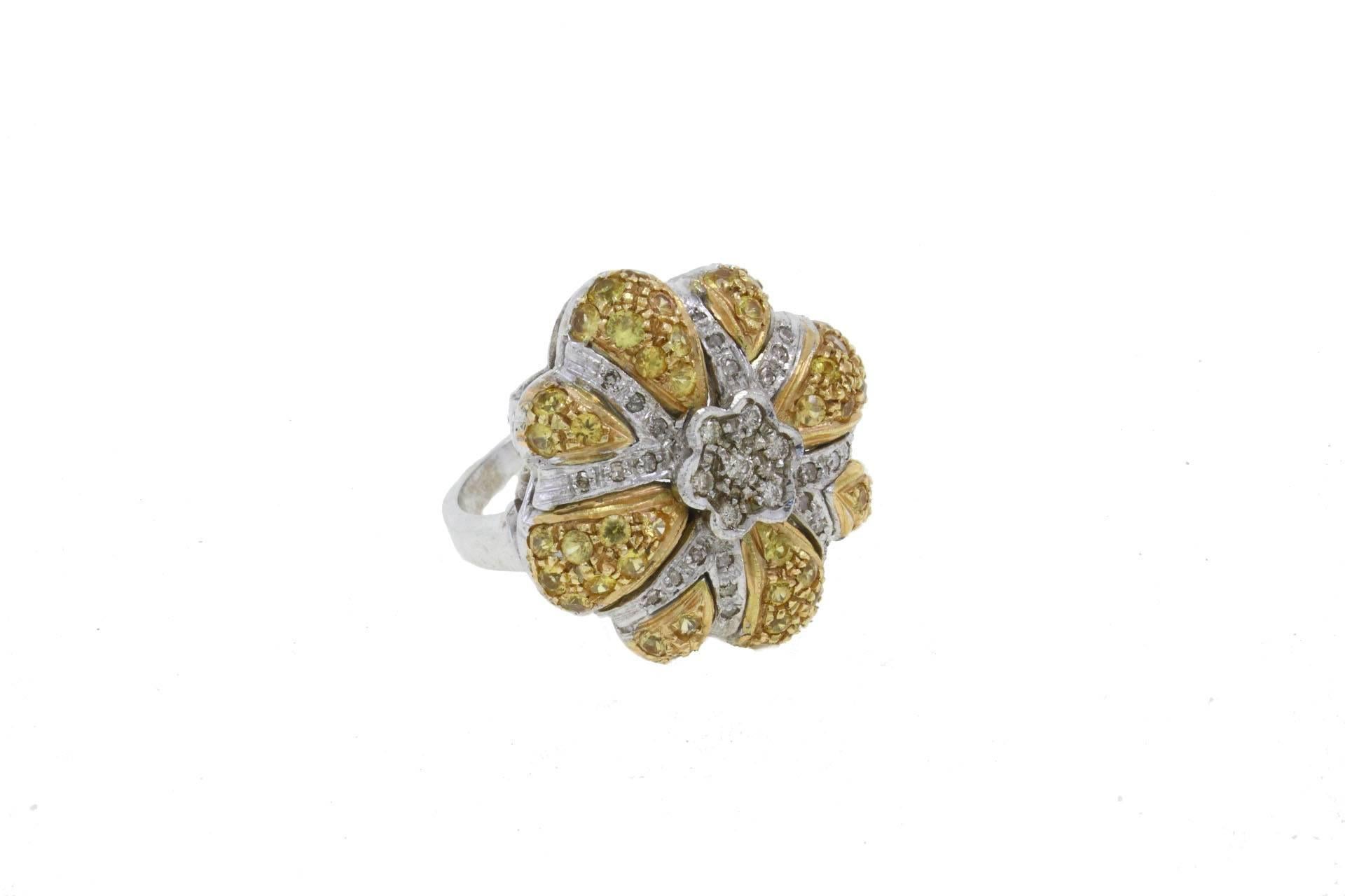 Graceful flower shaped ring in 14kt white gold covered in topaz and diamonds.

Diamonds 0.39 ct
Sapphires 2.47 ct

The ring can be adapted to the required size.
This ring complete the set with earrings and pendant refer to 
Luise Diamond Topaz Gold