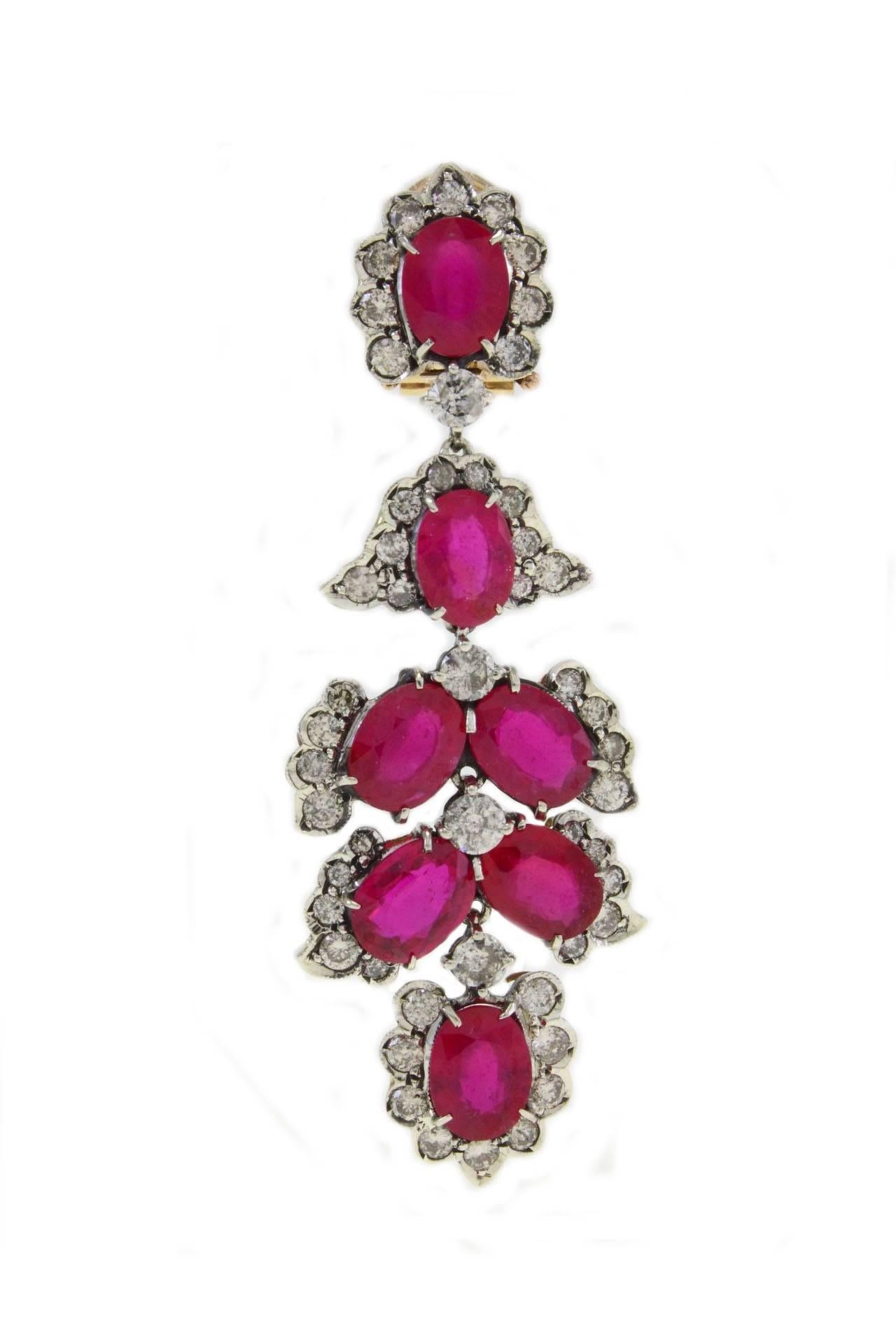 Classic and shapely chandelier earrings in 14K gold embellished with rubies teardrops each drop is surrounded by  diamonds and details in silver.

rubies  (27.52 Kt) 
diamonds  (5.58Kt) 
details in silver (4.48gr)
tot weight 16gr
Ref. Cod. ircr
US