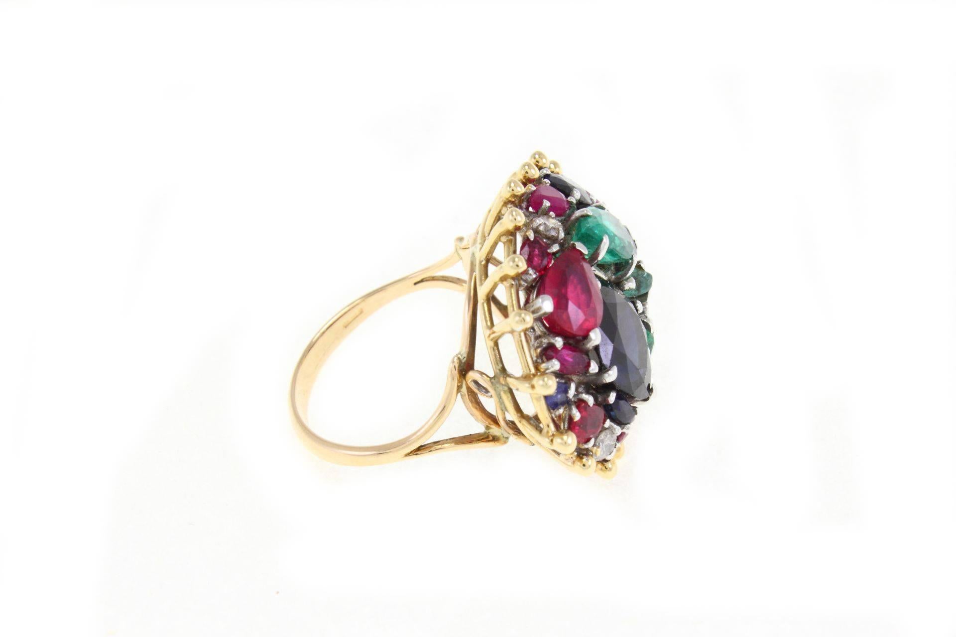 Sparkling ring in 14Kt gold composed of sapphires, emeralds and rubies surrounded by little diamonds.
diamonds(0.30Kt). 
sapphires, emeralds and rubies (8.5Kt) 
RF   +FIHA
RK.AFOH80
Italian Size 15,5
Usa Size 7,34
French Size 55,50
Width 1.10