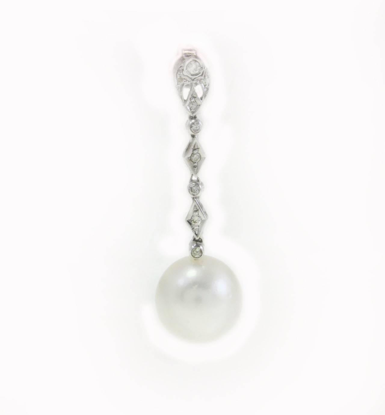Dangle earrings in a 14Kt white gold composed of a chain of diamonds with a medium size pearl at the end of it. These are delightful pairs of earrings that you will not resist to wear in any occasion.

diamonds(0.45Kt)
pearls (7.90gr) 
tot weight