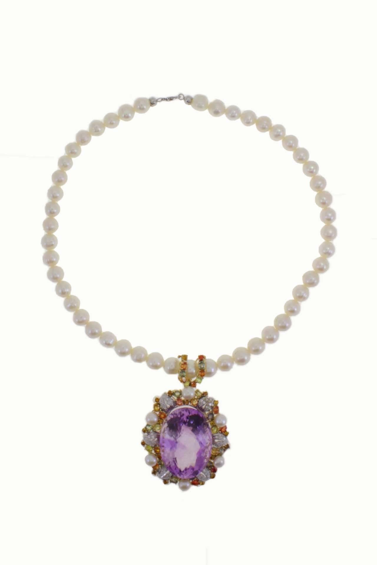 Beaded necklace with a oval amethyst pendant in 14Kt white gold surrounded by diamonds and multicolor sapphires. The clasp in 18Kt white gold.

diamonds and multicolor sapphires(98.62Kt)
pearls  diameter between 7/8mm (47gr) 
tot weight