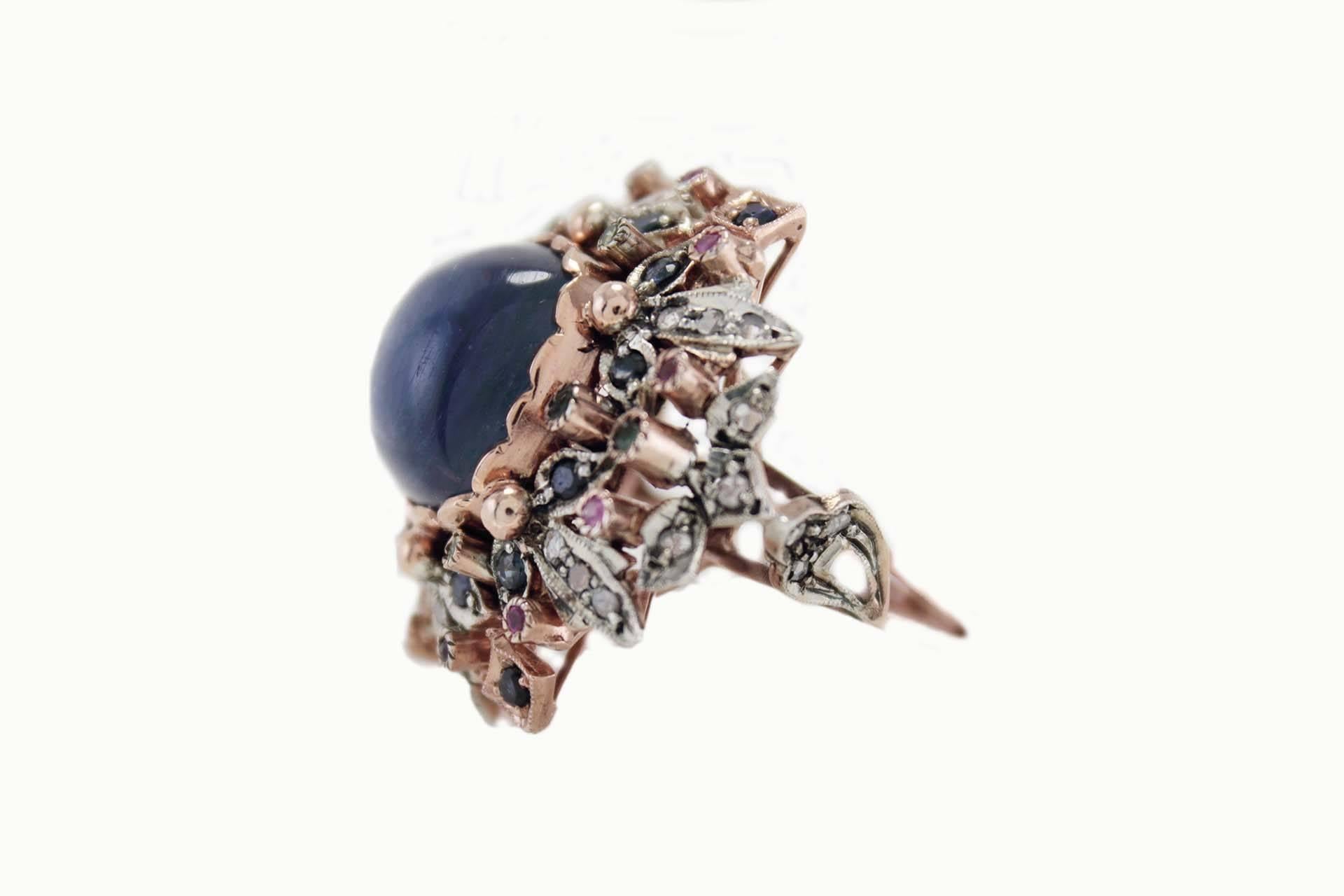 Charming ring in 9Kt gold and silver composed of a central square of Cianite or Kyanite surrpunded by a crown of multistone sapphires, emeralds and rubies with little details of diamonds.

multistone sapphire, emerald and rubies(tot weight