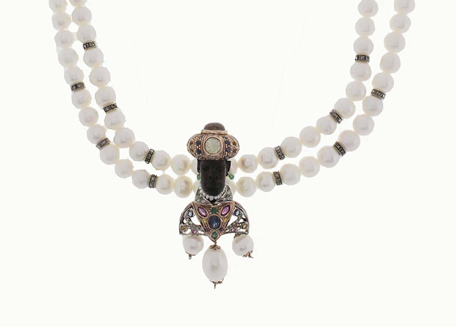 Another piece of fine jewelry. This beaded Necklace linked with depicting Venetian Moretti pendant exhibit a meticulous craftsmanship.
The necklace is composed of two rows of pearls.
The Moretti pendant is composed of:
The turbant is adorn it with