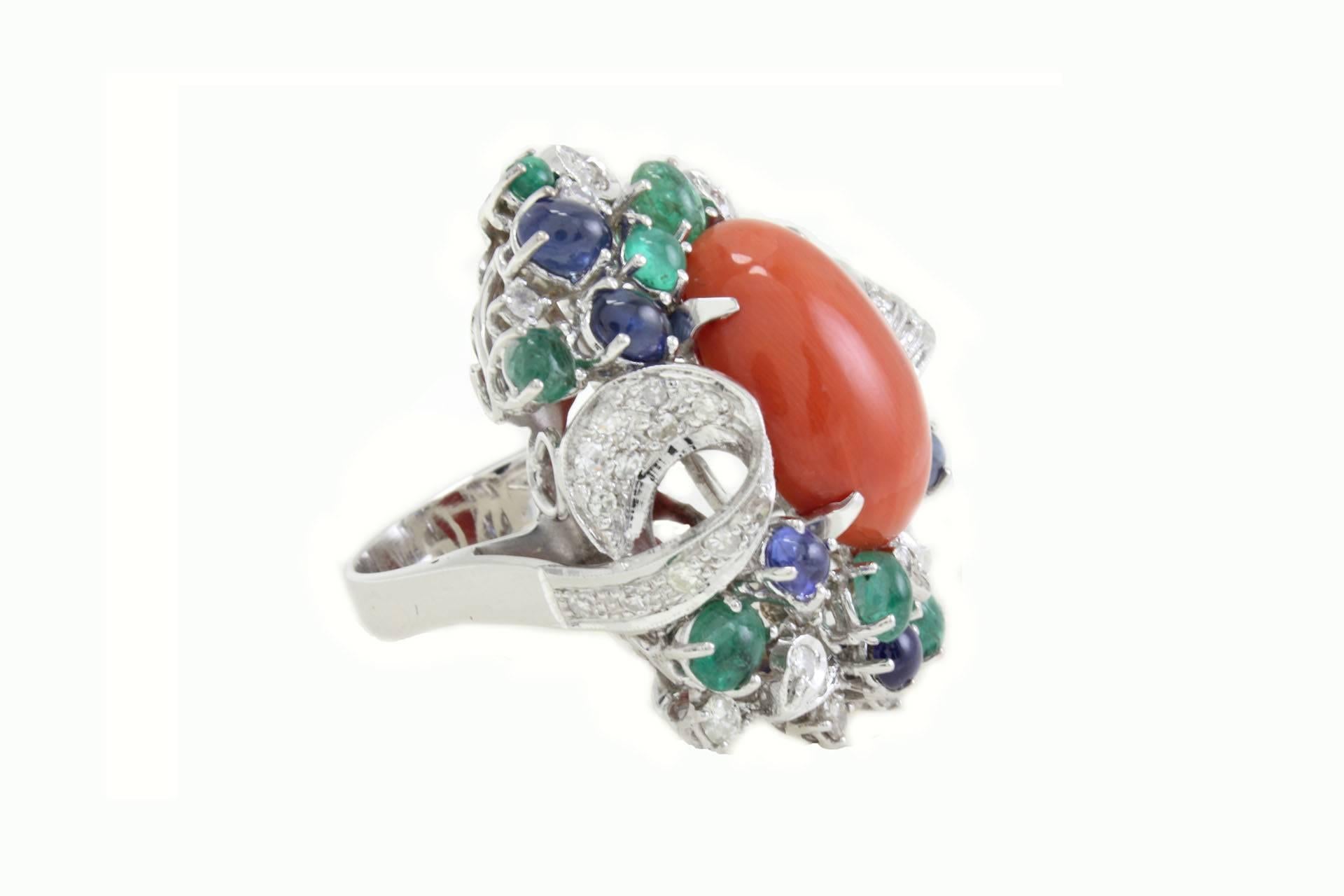 Classic cluster ring in 14Kt white gold embellished with a shapely balance among diamonds, blue sapphires and emeralds, all together are a frame for the central coral.

diamonds(1.60Kt), 
blue sapphires and emeralds(6.10Kt),
coral (2.30gr)
tot