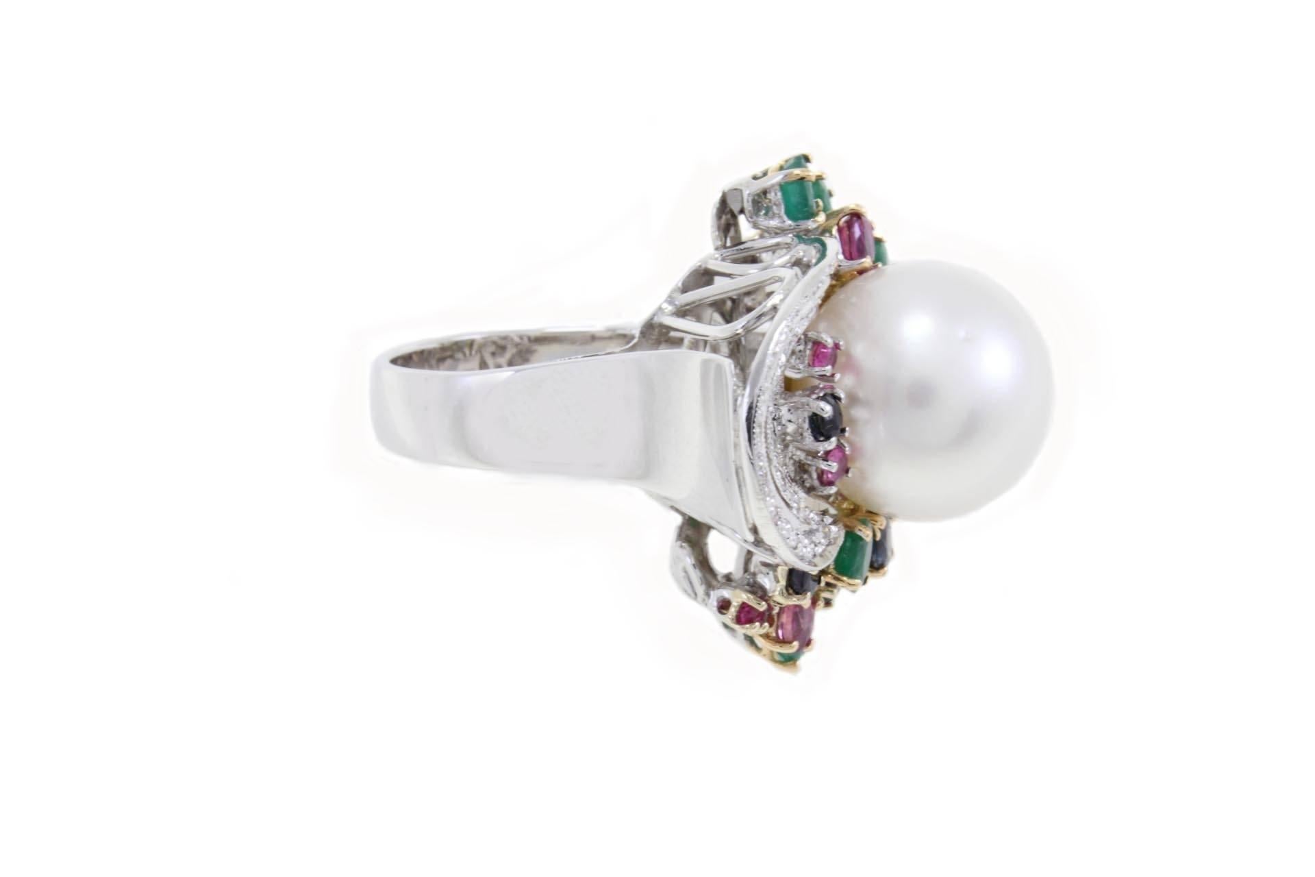 

luise multi-colored ring in 14 kt white and yellow gold with an Australian south sea pearl 14 mm. surrounded by a crown of rubies, emeralds and sapphires, and lines of diamonds.
rubies, emeralds, sapphires ( 3,78 kt)
diamond (0,28kt) 
Total weight