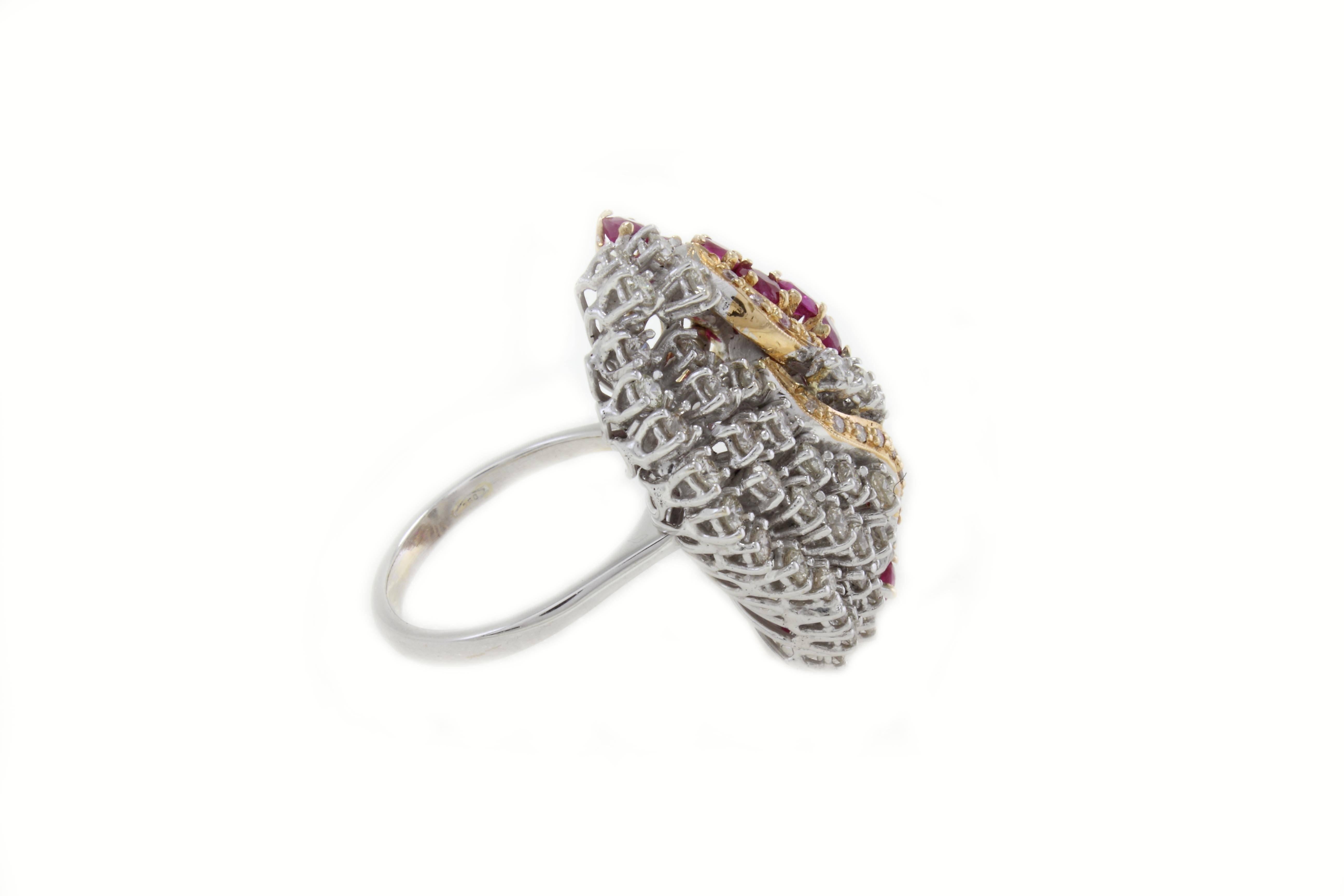 Fantastic ring in 18Kt white gold and details in yellow gold covered in shining diamonds and rubies. 

diamonds (1.48Kt)
rubies (3.7Kt). 
Tot. weight 12.9gr
Rf. ogur