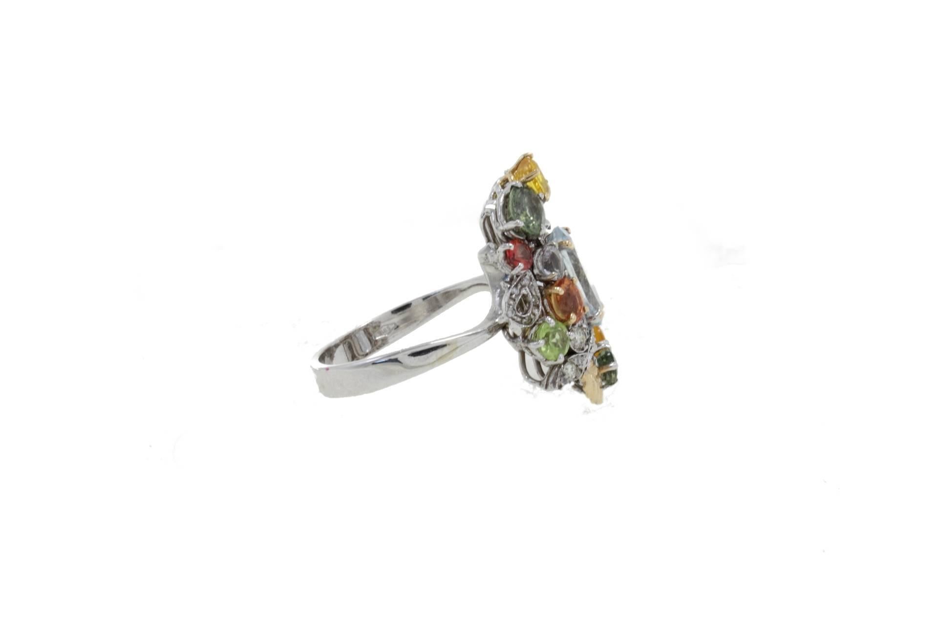 Cocktail ring in 14k white gold mounted with a central aquamarine surrounde by diamonds, peridots, multicolor sapphires and  topaz.

Diamonds 0.26 kt
Peridots, Multicolor Sapphires, Topaz, Aquamarine 5.76 kt
Tot.Weight 7.70 gr
R.F gerc