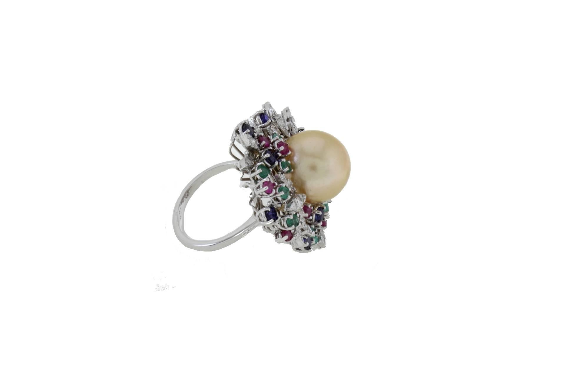 Cluster ring in 14k white gold mounted with one yellow south sea pearl in the center and diamonds, emeralds, rubies, blue sapphires all around it.
Diamonds 1.55 ct
Emeralds, Rubies, Blue Sapphires 3.38 ct
Pearl 3.60 gr/ 13.50 mm
Total Weight 14.50