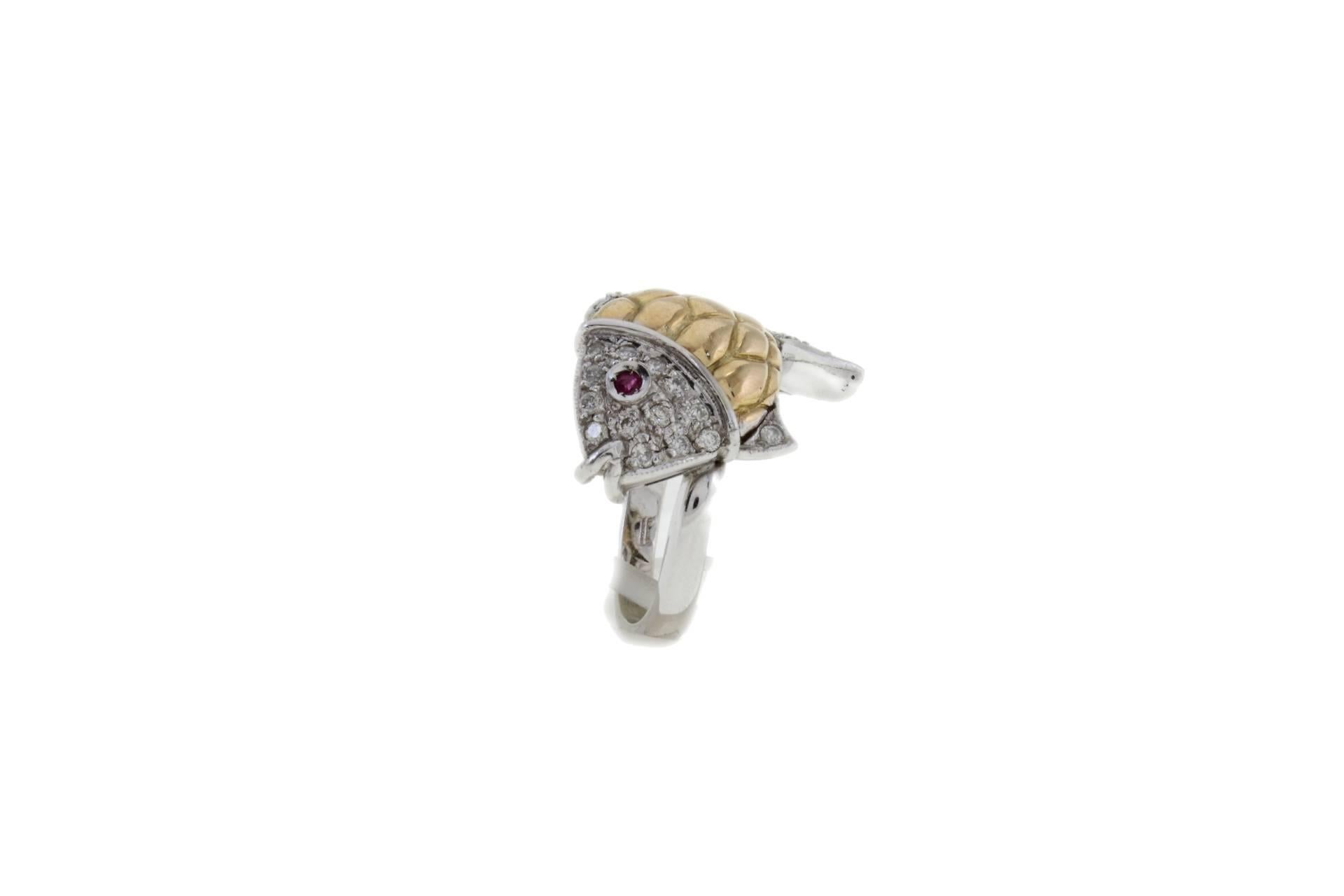 shipping policy: 
No additional costs will be added to this order.
Shipping costs will be totally covered by the seller (customs duties included). 

Fish shaped ring in 14k white and yellow gold mounted with diamonds on the body and one ruby as