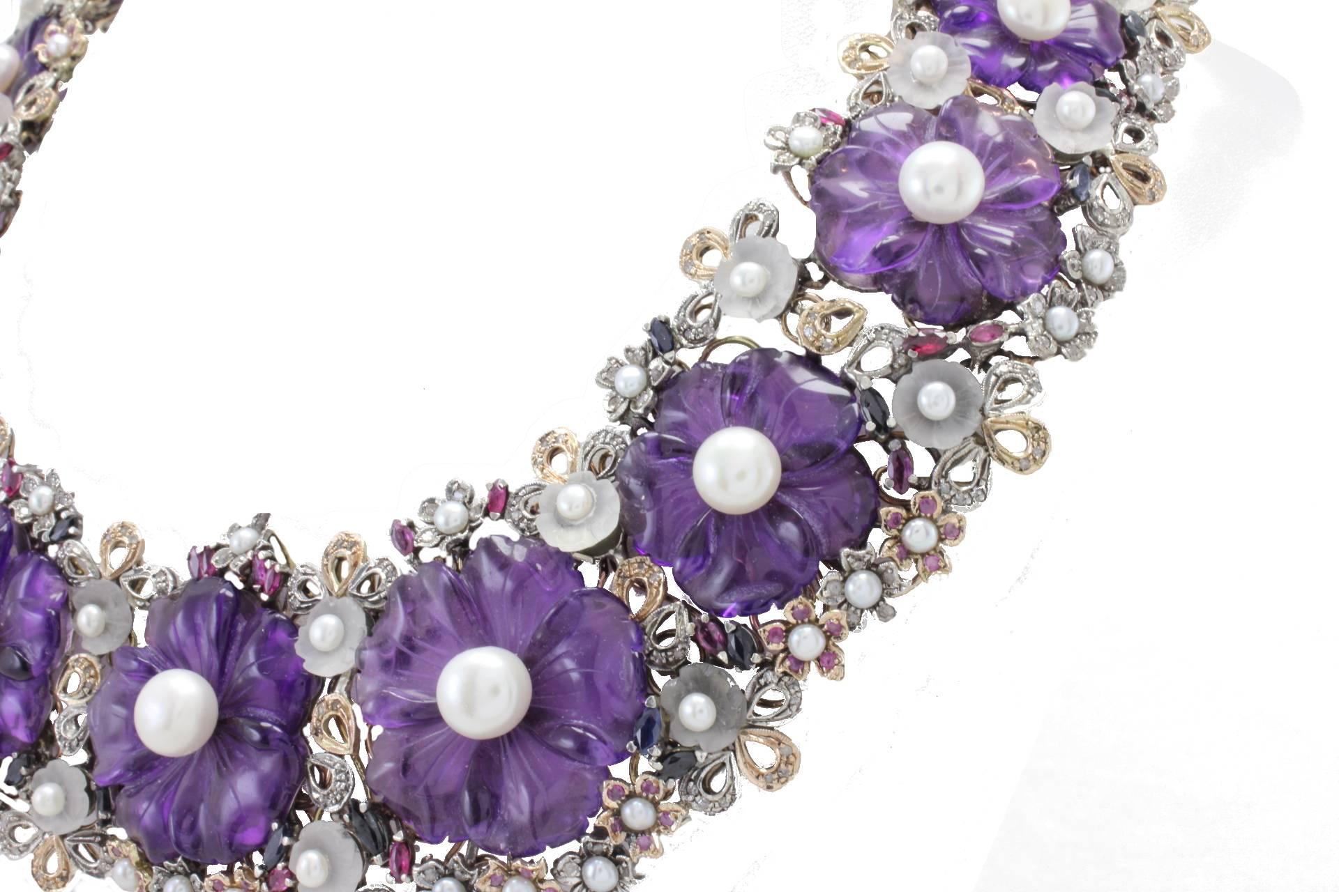 Charming and fashion design necklace, composed of flower shape amethyst and rock crystal (54.1Kt) with a diameter between 3-7mm(13.20, diamonds(5.66Kt) and emeralds, rubies, and blue saphires(14.55Kt). All mounted on 9Kt gold and silver. Tot weight