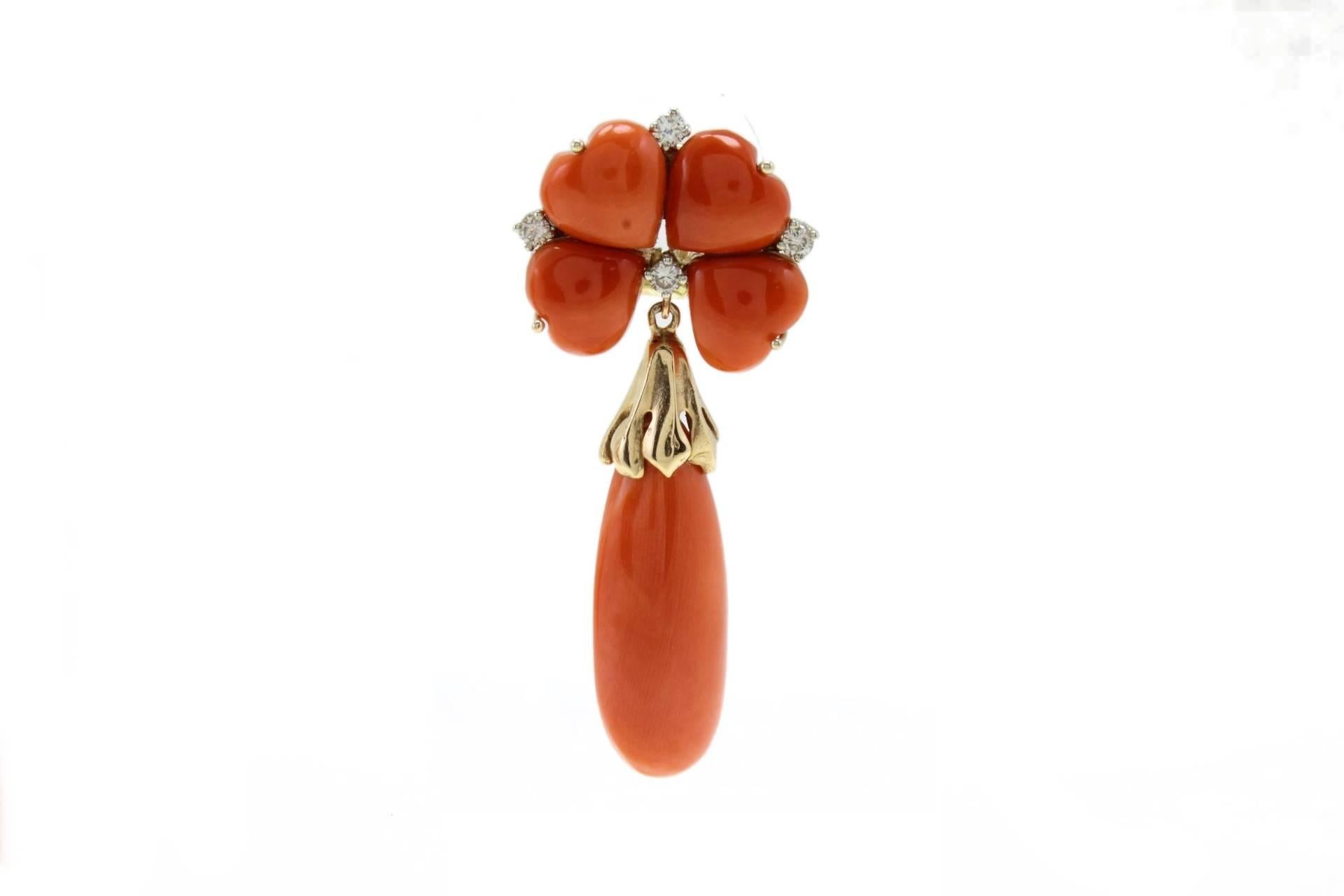 Classic and  delightful coral earrings. The top coral is shaped as petals embellished of diamonds among them, to link the flower a 14Kt gold little clasp that holds the coral drop on the bottom on the bottom.
Diamonds 0.48 Kt
Coral 9.90gr
Tot weight