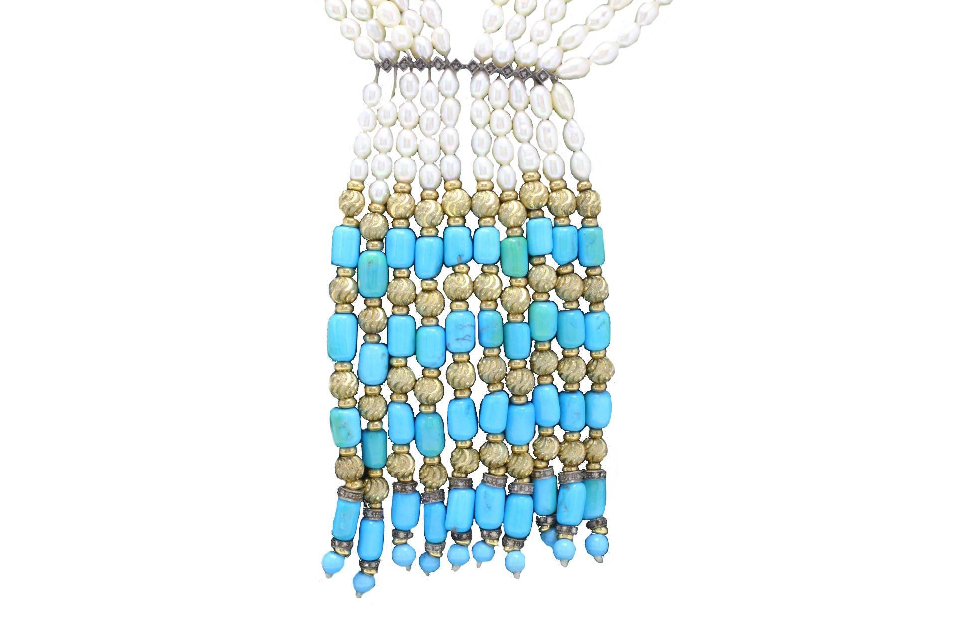 A classic evergreen necklace in gold and silver composed of 10 strands of pearls linked to an alterning of gold and turquoise. in the middle a line of silver covered in diamonds. 

gold 9kt 8.38gr
silver 20.9gr
diamonds 1.10kt
pearls