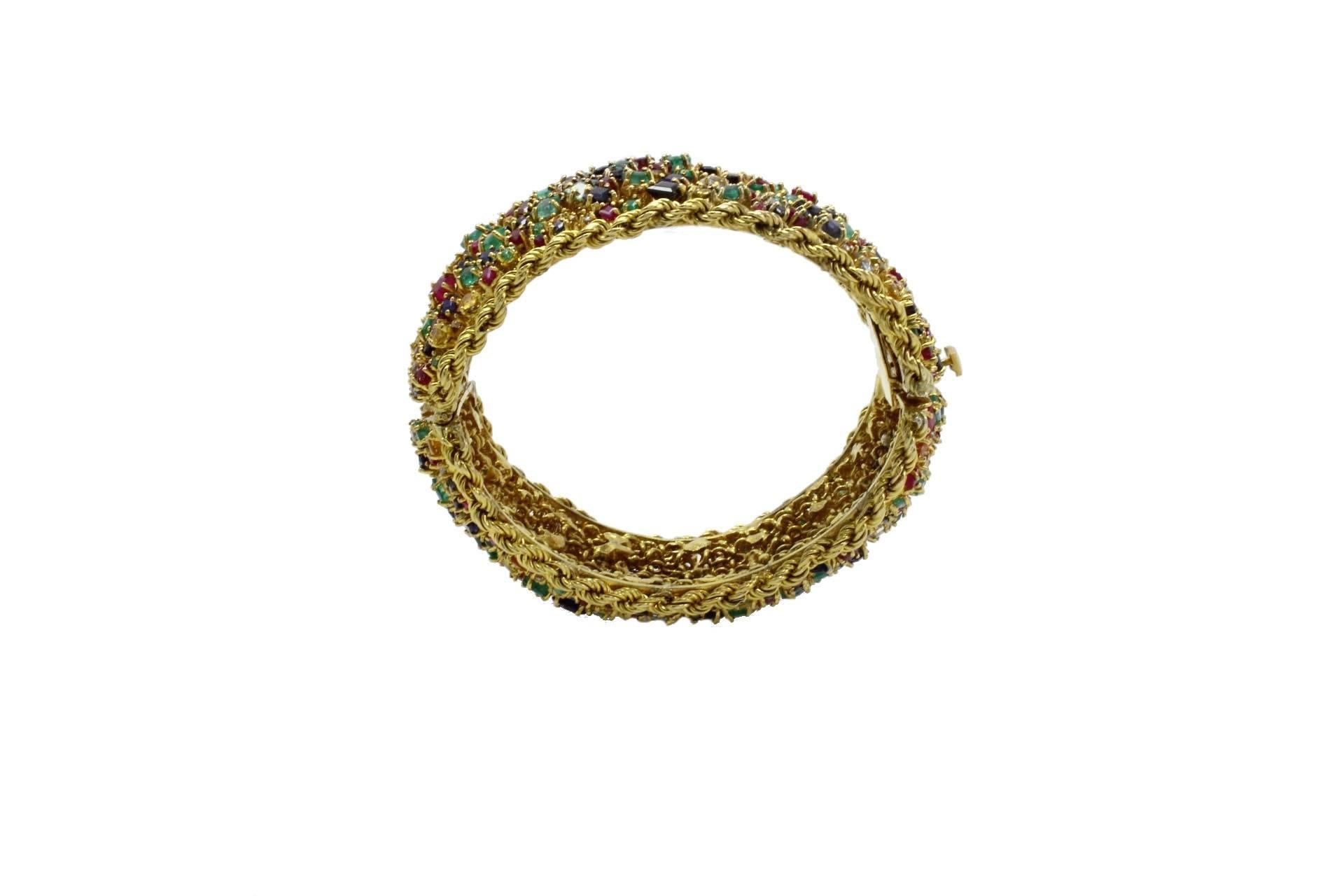 Shiny clamper bracelet in 9kt yellow gold covered in diamond, multi-color sapphires, ruby, emerald, and aquamarine.

diamonds 0.65kt
gems 60.65kt
tot weight 89.1gr
r.f.   rcuo