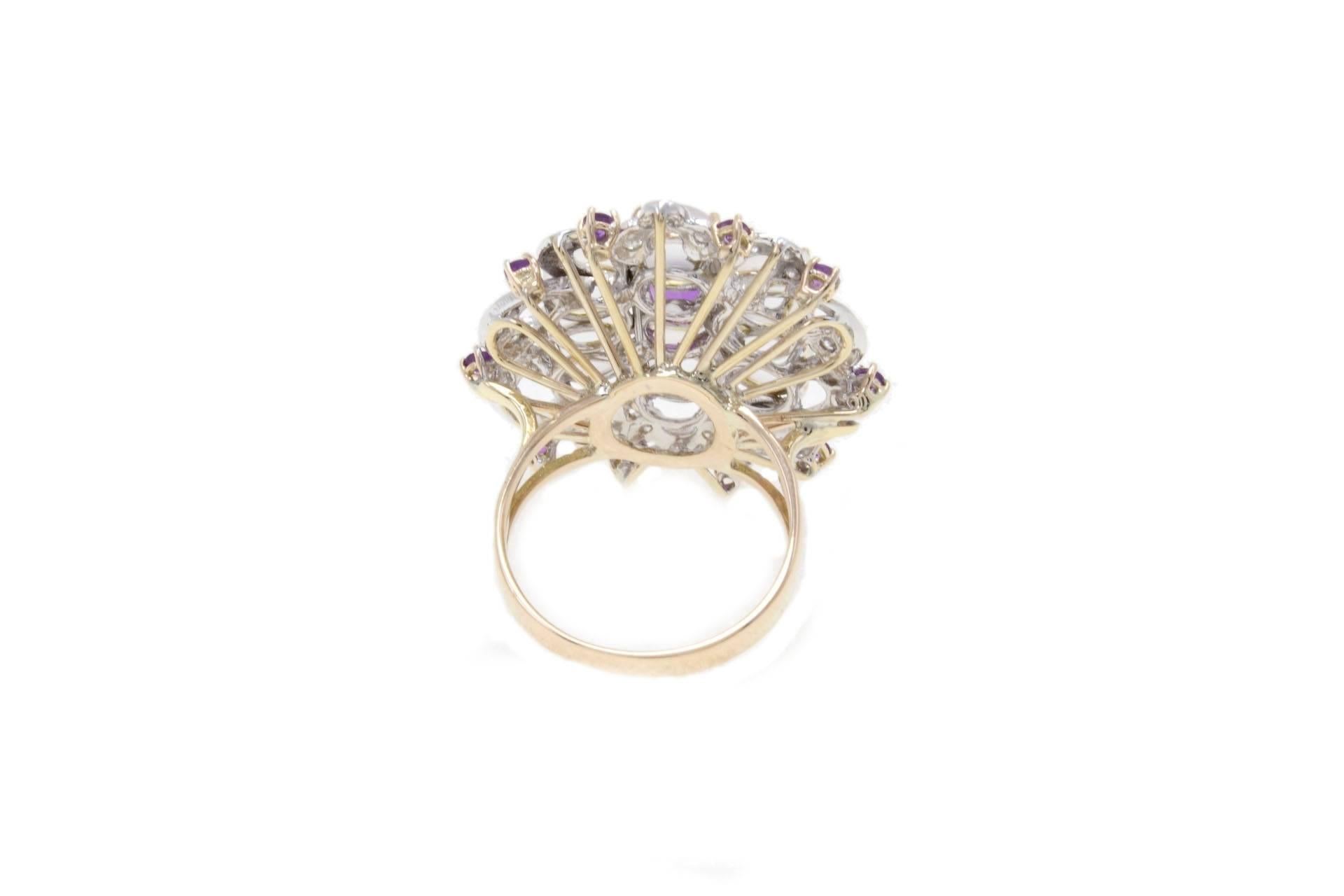 Cluster flower shaped ring in 14kt yellow gold composed of a central amethyst surrounded by rock crystals and a crown of diamonds and amethysts.
gold 9.42gr
diamonds 0.48kt
amethyst 0.44kt
rock crystals 1.50gr
tot weight 11.2gr
ref fgha