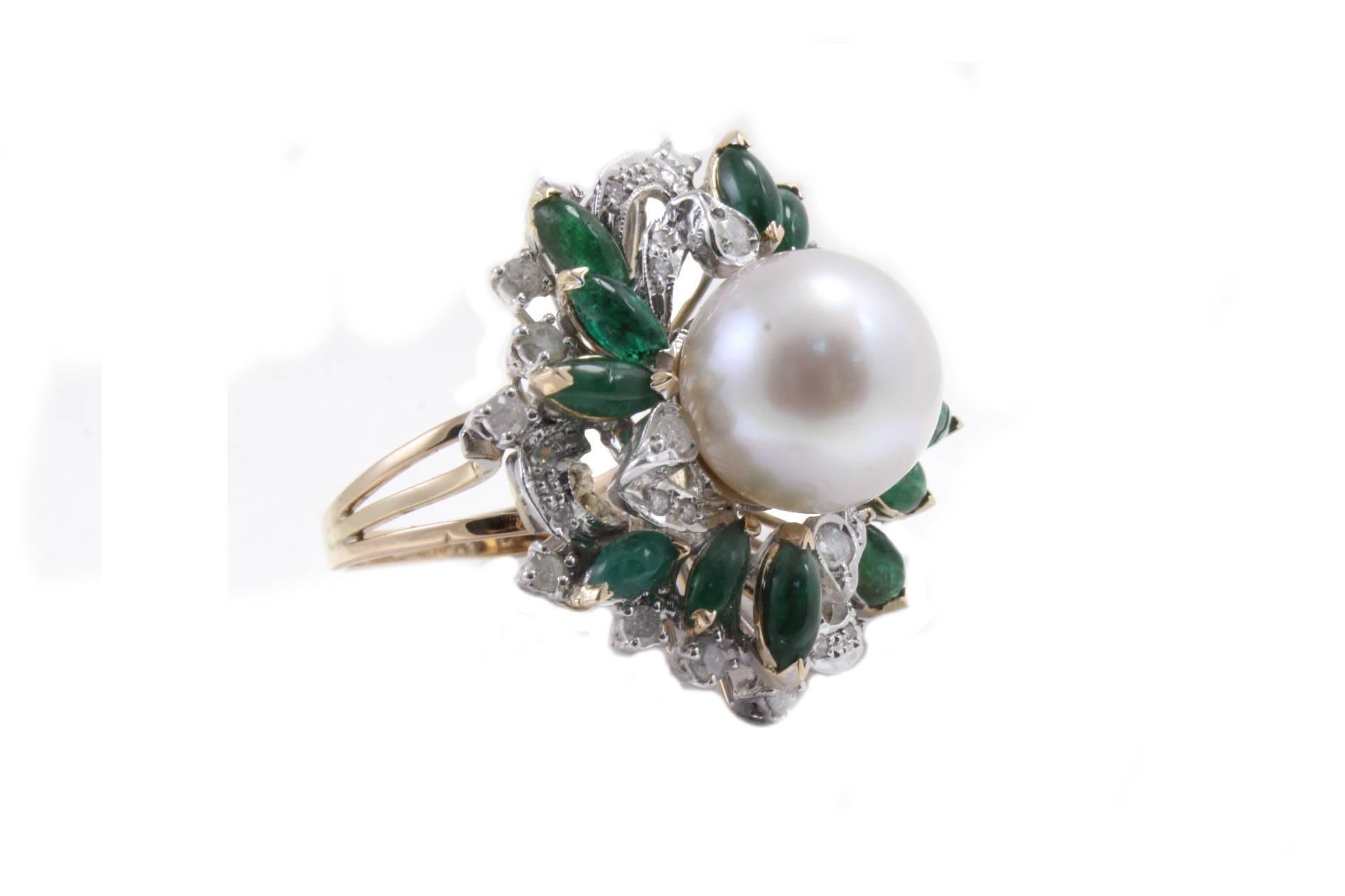 Delightful ring in 14kt yellow gold and white gold composed of a cluster of diamonds and emeralds cabochon navette cut with a australian white pearl in the center of them.

Size ring: US 8 - ITA 17 - French 57 - UK Q
Tot weight 16.6 gr
Diamonds 1.38