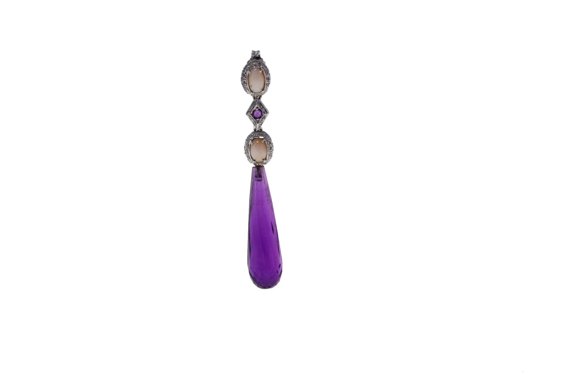 Dangle earrings in 14kt white gold composed of two pink corals surrounded by diamonds linked together by a rhombus of dioamonds with a central amethyst. On the bottom a drop of amethyst.

diamonds 0.30kt
tot weight 9.0gr
r.f.  gcuf