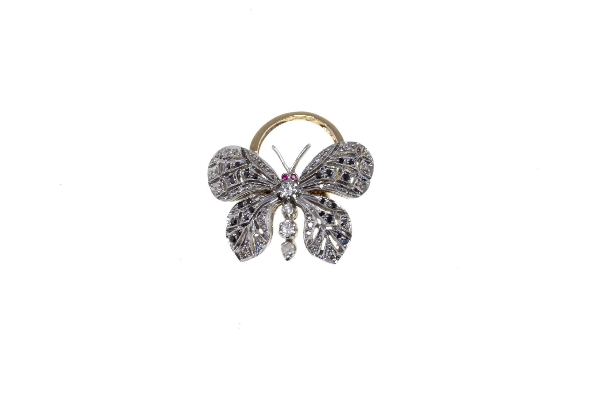 

Shiny ring in 9kt rose gold and silver with a very original movable band. composed iof a butterfly covered in diamonds and blue sapphires. Two rubies as eyes.
diamonds 1.21kt
tot weight 14.2gr
r.f.  gchi

For any enquires, please contact the
