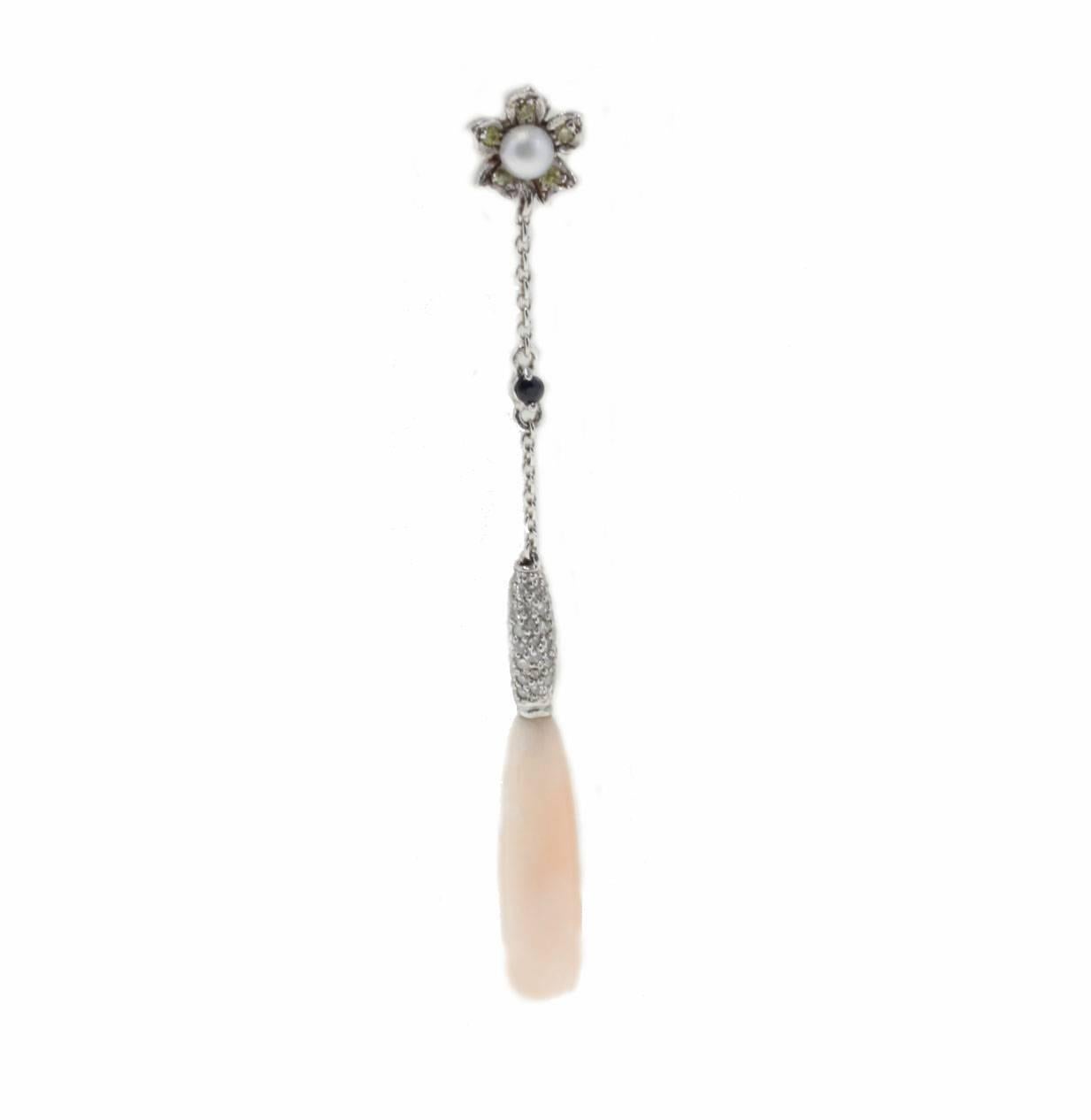 These are classic drop earrings that they could be worn with different outfit style. They are made in 14 Kt white gold, on top of a light pink natural coral, there is a little daisy with yellow diamonds as petals and on centrer of it a delicate