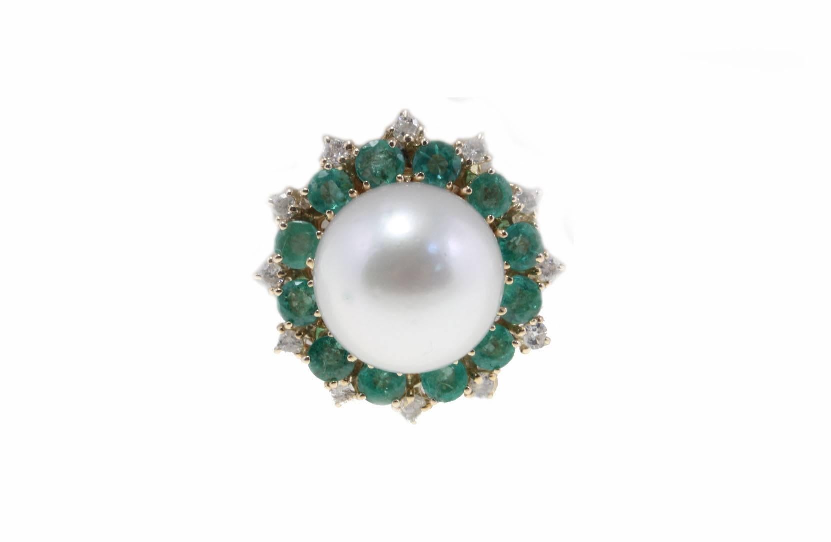 These charming earrings are simply composed of a crown of diamonds  and emeralds that surrounding a natural large sea south pearl, all is mounted in 14Kt yellow gold.

Tot weight 21.2 gr both, single one 10.6 gr.
Diamonds 0.80 Kt
Emeralds 4.67