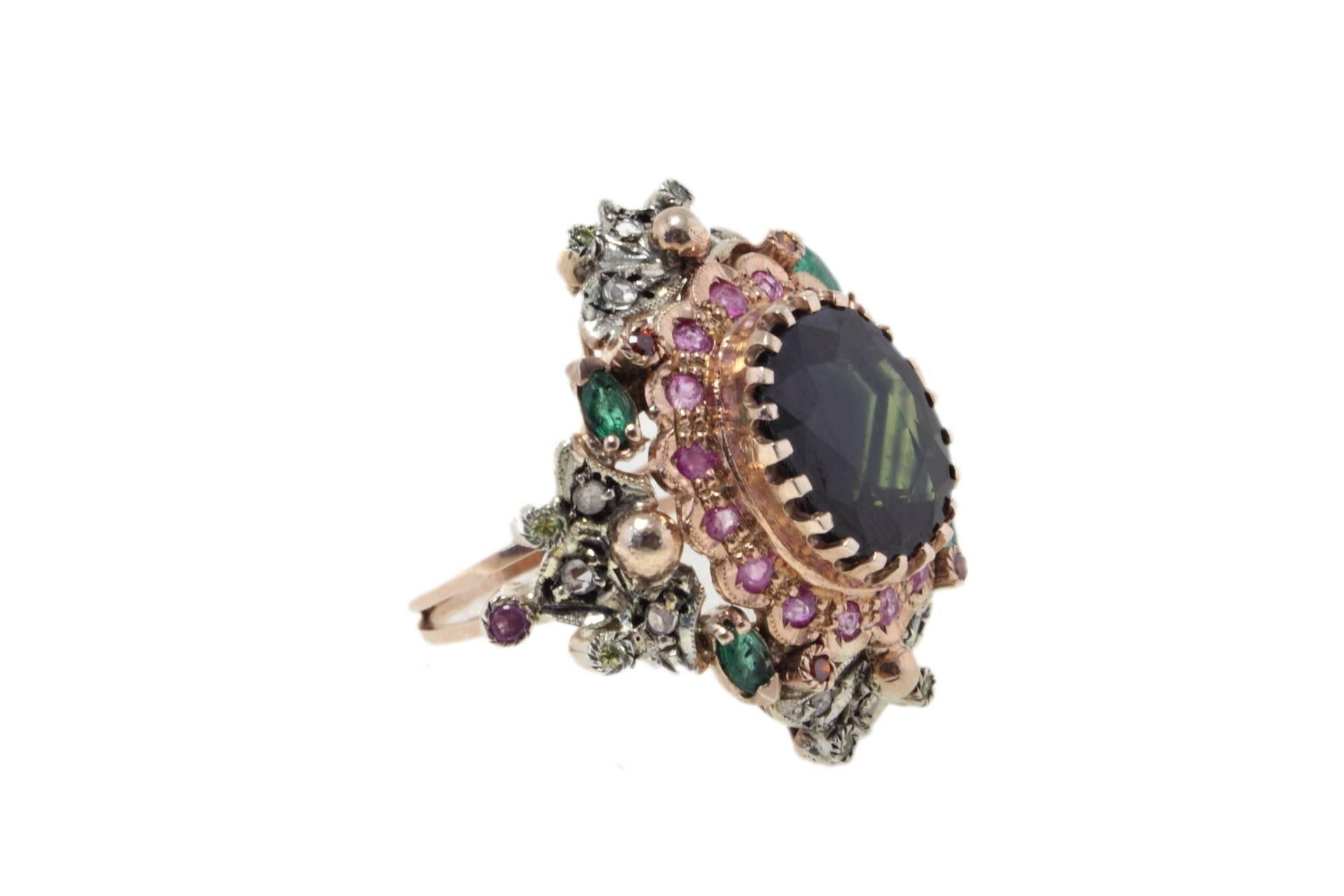 Charming and shiny dark sapphire surrounded of emeralds, rubies, diamonds and multicolored sapphires. All these sparkling gemstones are mounted on a 9 K rose gols and silver ring.
Ring Size ITA 16 - French 56 - US 7.5 - UK P
Tot Weight 11.3