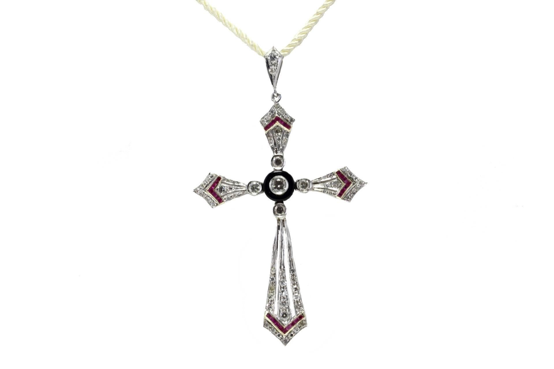 SHIPPING POLICY:
No additional costs will be added to this order.
Shipping costs will be totally covered by the seller (customs duties included).

Diamonds cross pendant in 14kt white and yellow gold embellished with rubies stripes and a centra disc