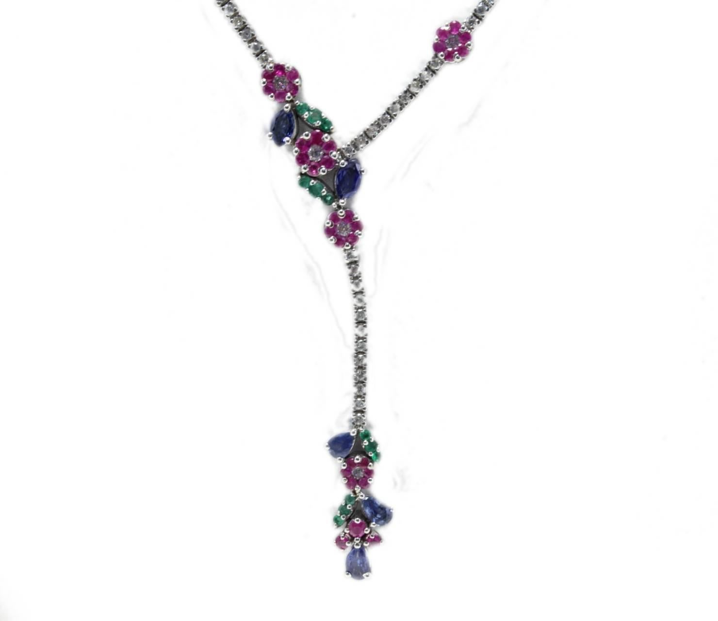 Fascinating necklace  and earrings composed of diamonds string  with a little flowers of rubies, emeralds and blue sapphire on it, and a different design for the top of the string only in shiny 18K white gold. 
Tot weight Necklace 18.6 g
Diamonds