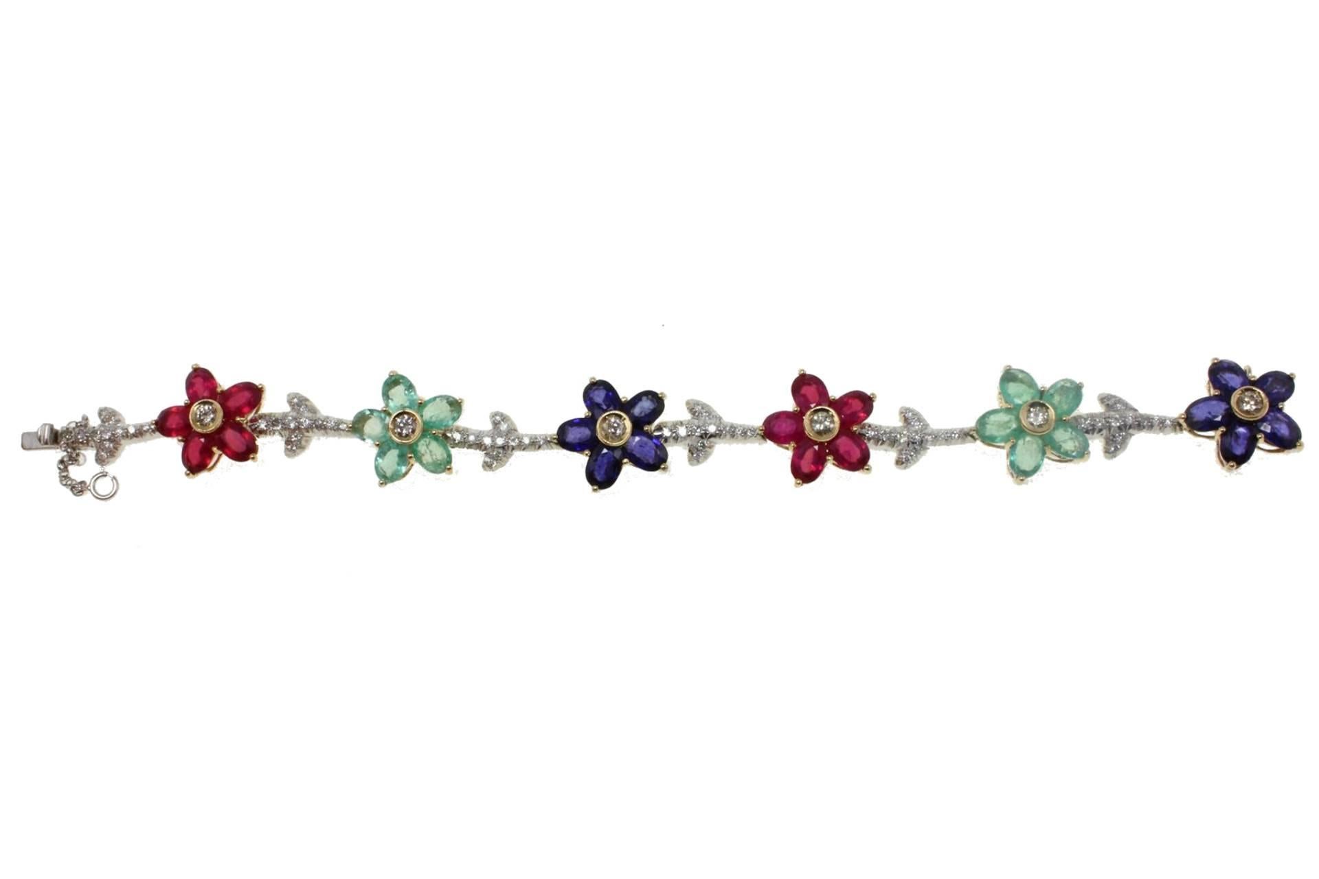 Shiny bracelet in 14kt white and rose gold composed of alternig rubies, sapphires and emeralds flowers. All linked by diamonds stems.

tot weight 25.8gr
r.f.  eegh