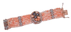 Bracelet en corail, saphirs, rubis, émeraudes, diamants, or rose et argent.