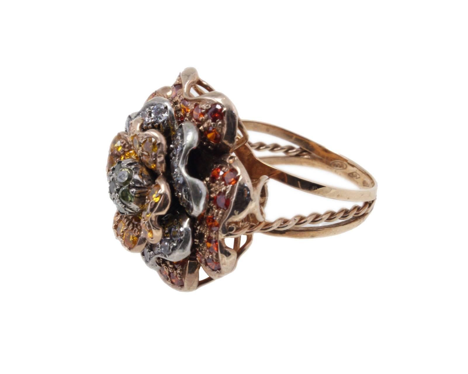 

Sparkling and graceful cocktail ring  All is mounted in 9Kt rose gold and silver. The cluster is composed of multi colored stones that make a flower.
Ring Size: ITA 15 - French 55 - US 7 - UK O
Tot weight 11.3 g
Stones 1.13 ct
Rf. iia    
For any
