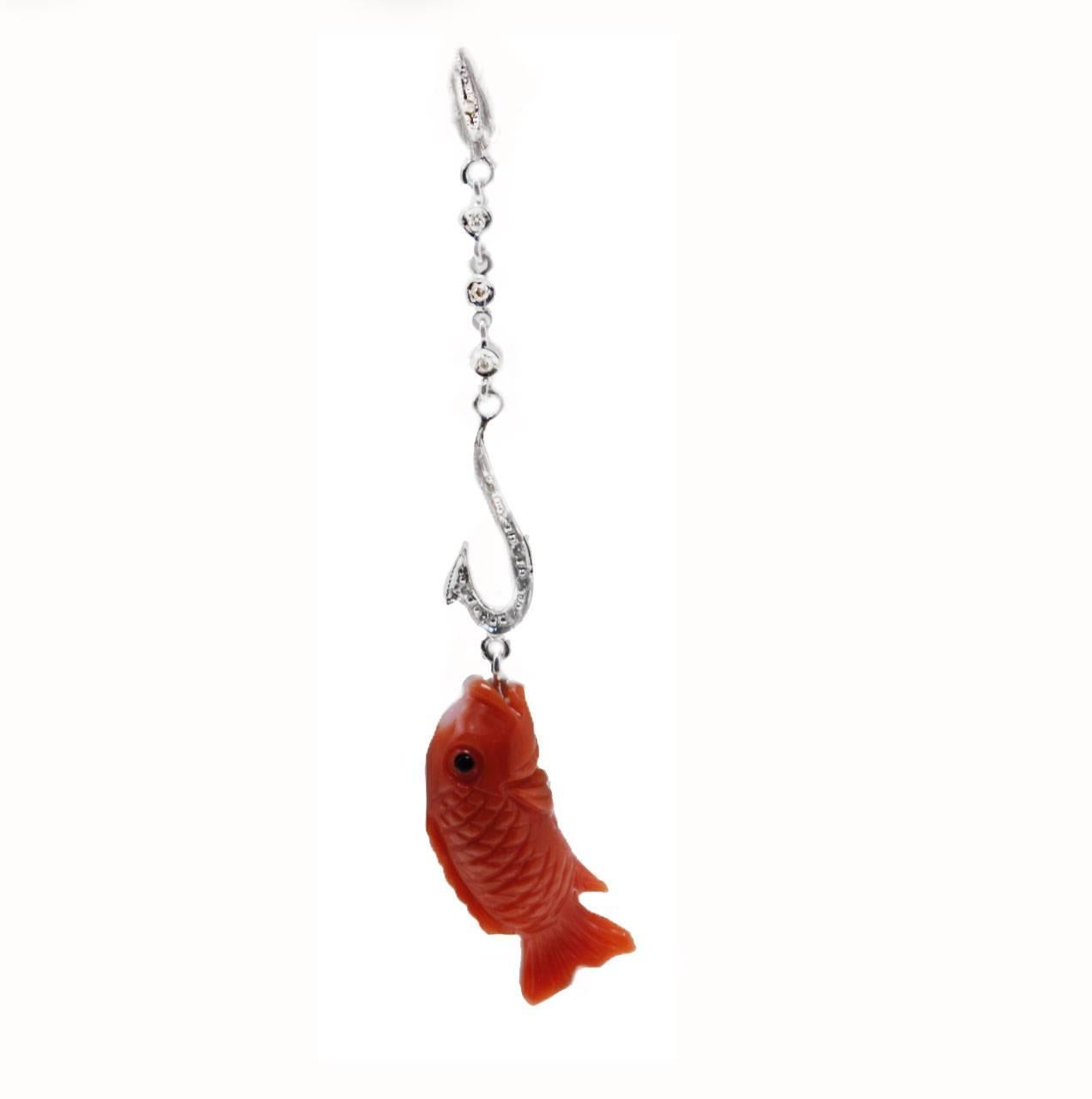 These fashion earrings are composed of a line of diamonds with a coral fish shape hanging from a the hook. All is set in 14K white gold.
Tot weight both earrings 3 g, single one 1.5 g
Diamonds 0.10 ct
Coral 1.70 g

Rf. efr