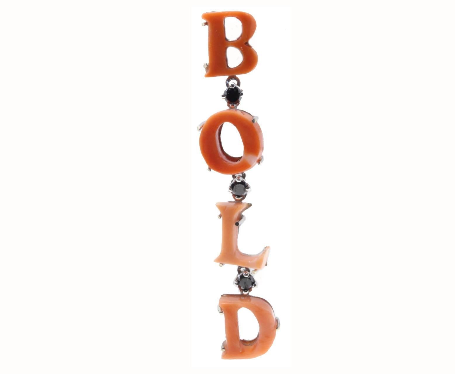 

If you feel and are a bold person these fashion earrings will tell that to everybody, the letters are settled in coral and among them to link them black diamonds and mounted on a base of 14K white gold.
Tot weight both earrings 5.4 g, single one