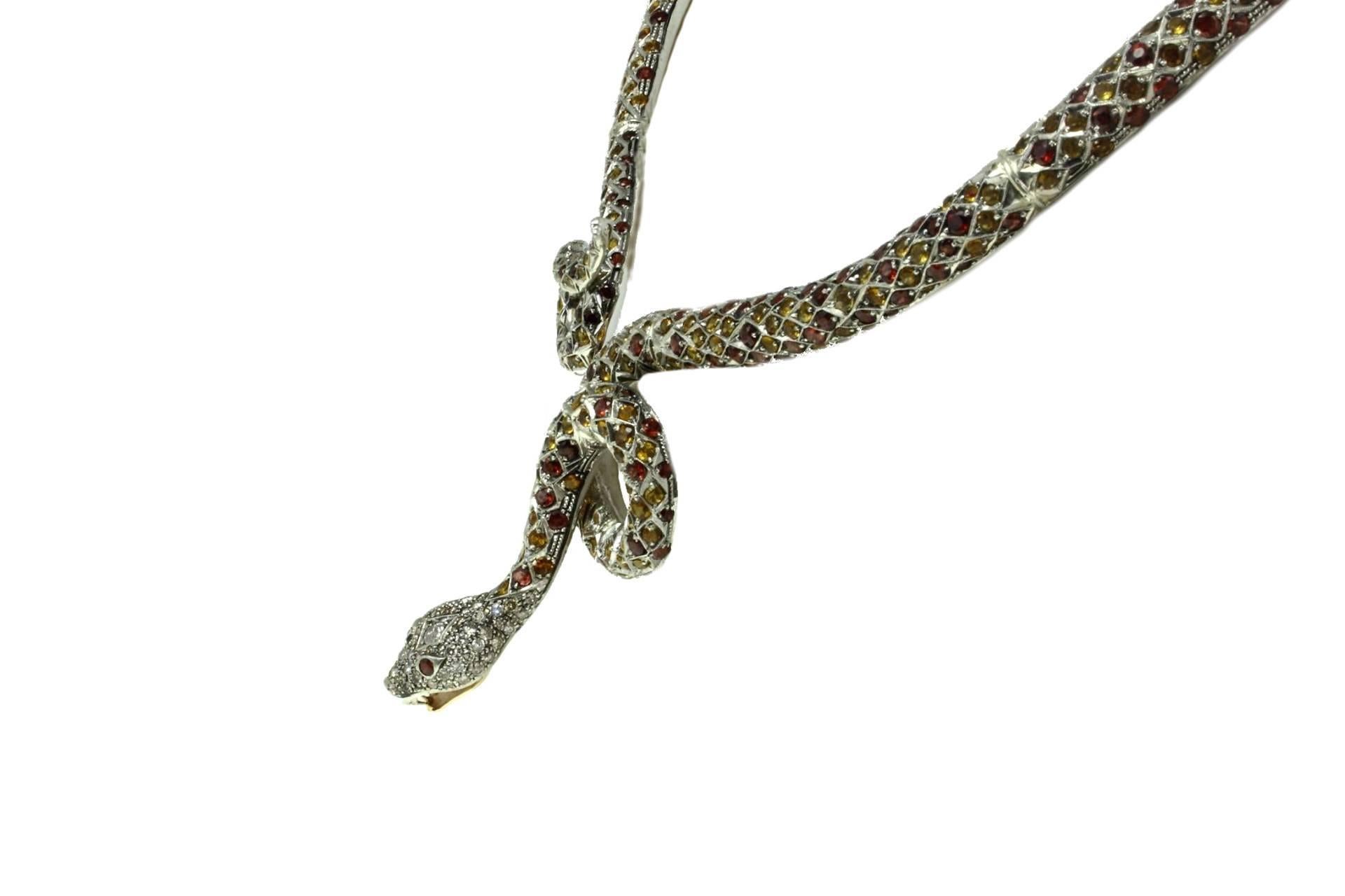 Amazing firm snake necklace in 9kt rose gold and silver. The snake body is all covered in garnets and topazes insteard the hera is covered in diamonds with garnets eyes.
total gemstone kt 80,00
diamonds 3.01kt
tot weight 102.0gr
r.f   ggiia