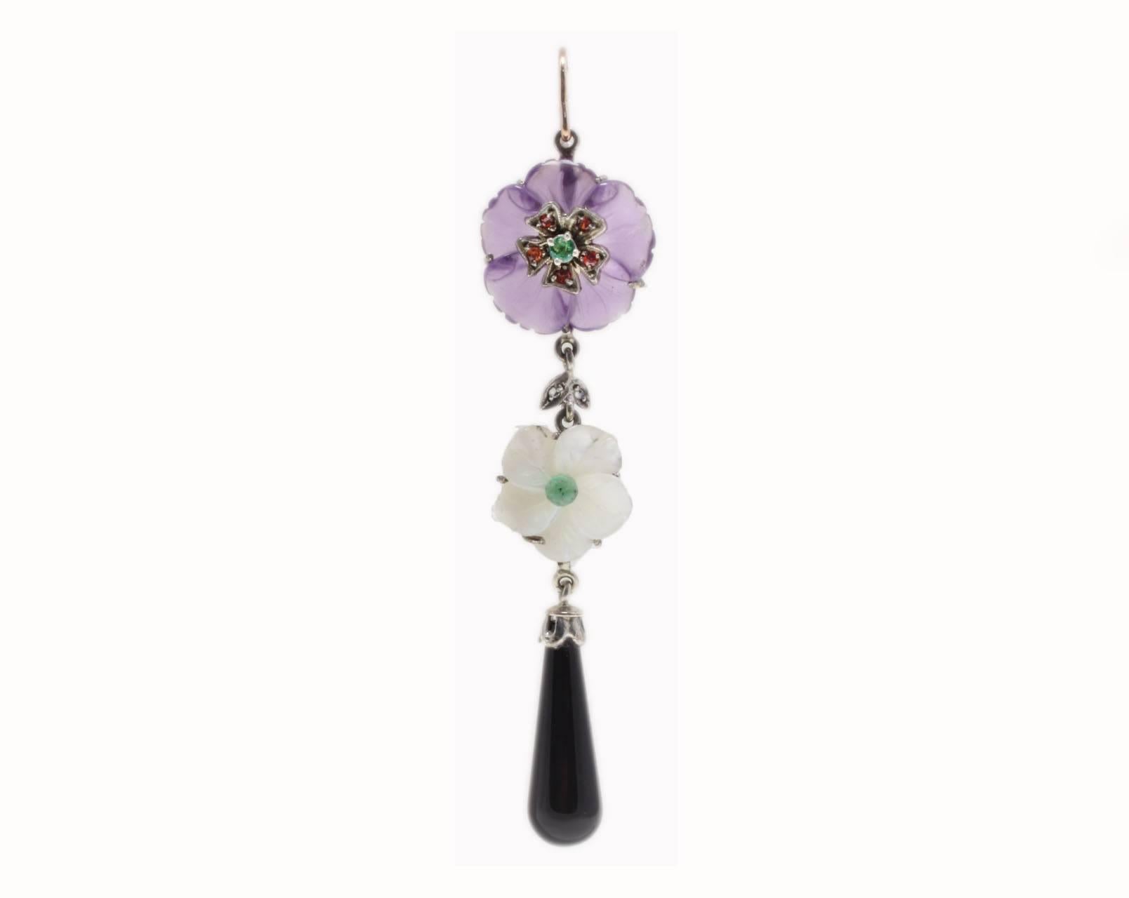 The simplicity in a classic drop earrings composed of 2 flowers, the biggest one on top is an amethyst flower with an emerald in the middle, the little one is a flower of mother of pearl  with also a emerald in the middle, both of them on top of a