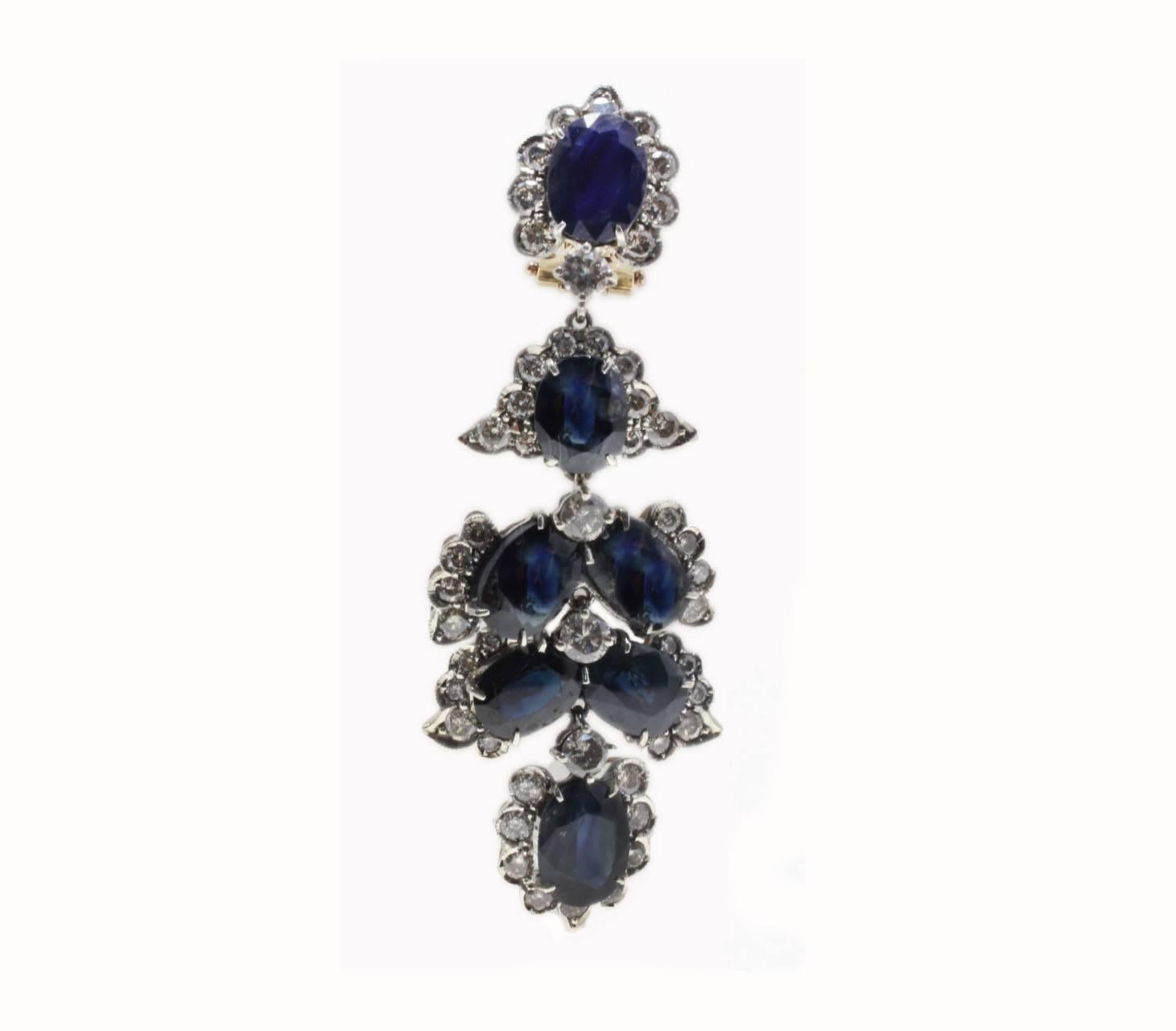 Classic and shapely chandelier earrings,  embellished with blue sapphires drops, each drop is surrounded by  diamonds. All is mounted in 14 Kt rose gold and details in silver.
Tot weight 16.2 g both earrings, single one 8.1 g
Diamonds 5.64 ct
Blue