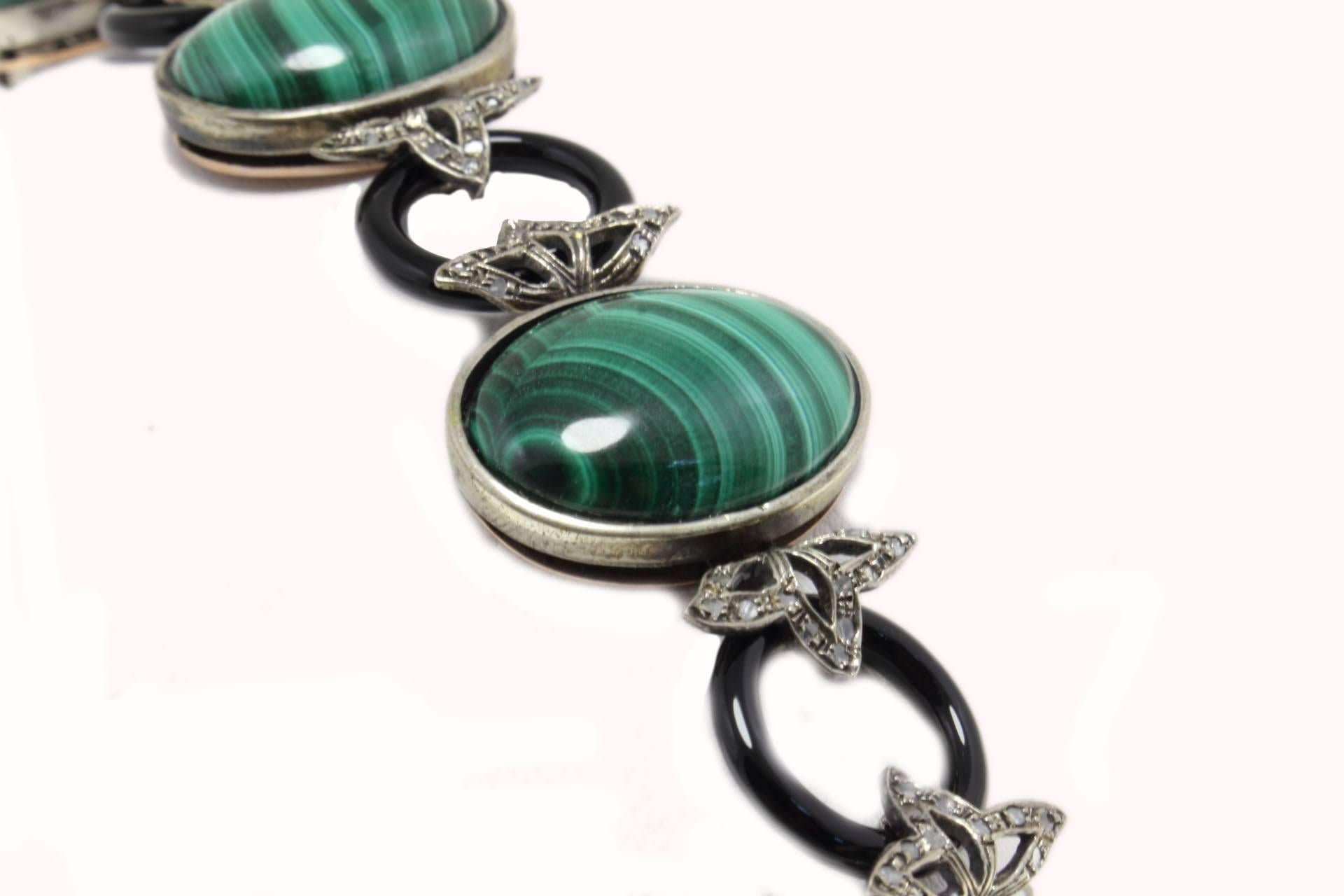 Amazing link bracelet composed of onyx circle that's links to a malachite stones with leaves of diamonds. All is mounted in 9 kt rose gold and silver.
Tot Weight 37 g
Onyx and Malachite 17.14 g 
Diamonds 0.61 ct

Rf. gahf