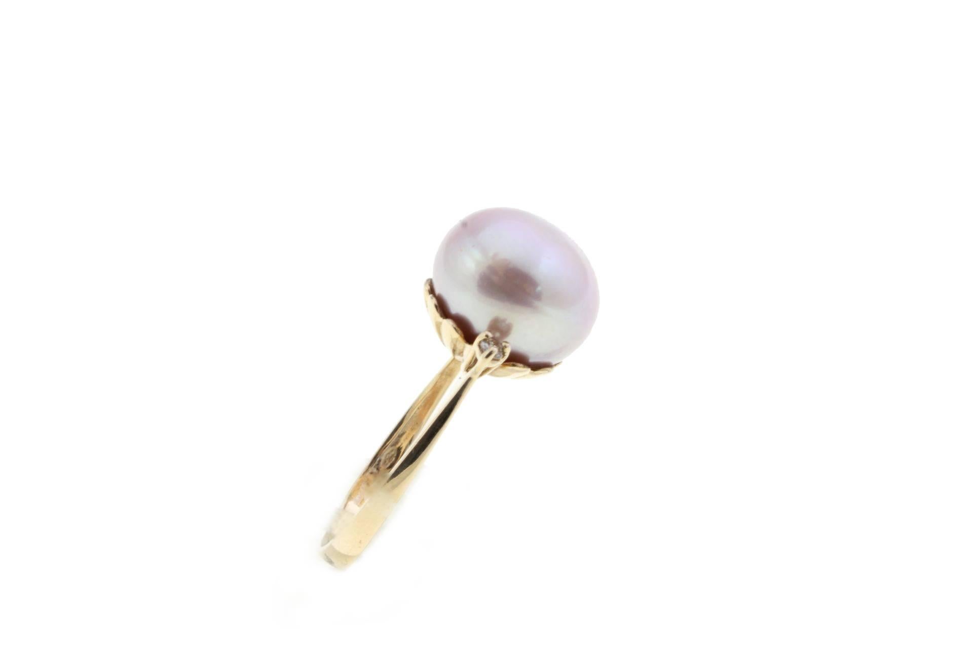 14kt gold ring compsed of a natural Rose pearl in the center and two diamonds to the sides.
Diamonds ct 0.08 
Pearl gr 2,60/13mm
Tot.weight gr 5,20
R.F ica
