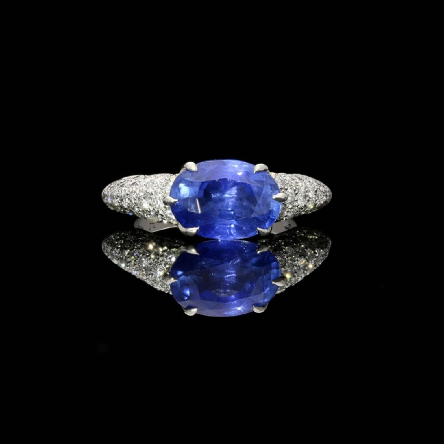 A beautiful sapphire and diamond ring by Hancocks centred with an oval blue unheated Sri Lankan sapphire weighing 4.76 carats claw set horizontally within a round brilliant diamond pavé set platinum mount.

Oval unheated sapphire 4.76 carat with