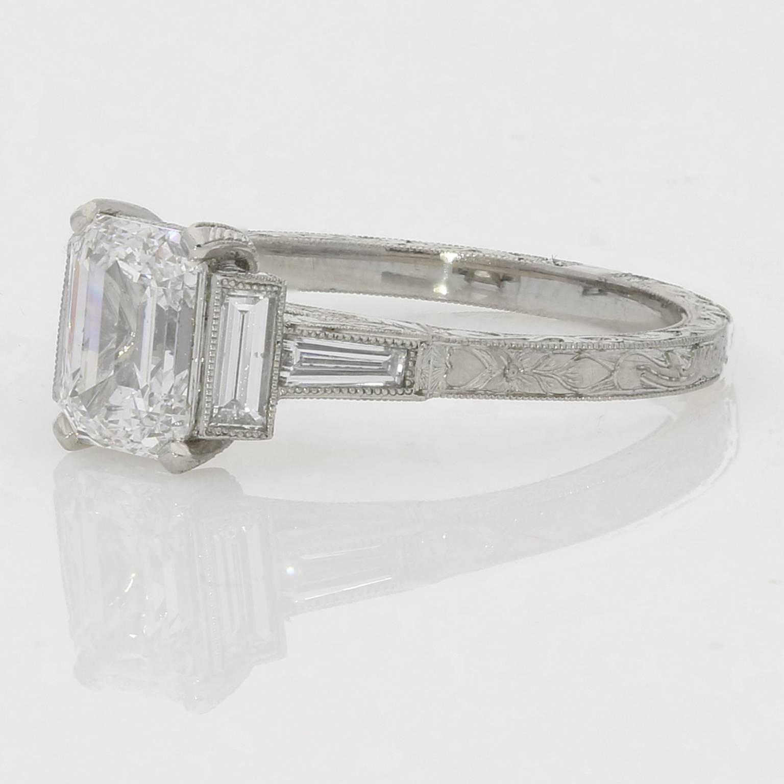 The centre diamond is claw set with a baguette diamond running parallel and a tapered baguette diamond leading into the hand-engraved platinum shank.

Hancocks, London

Contemporary

London, England

1.21ct D VS2 emerald cut diamond with GIA