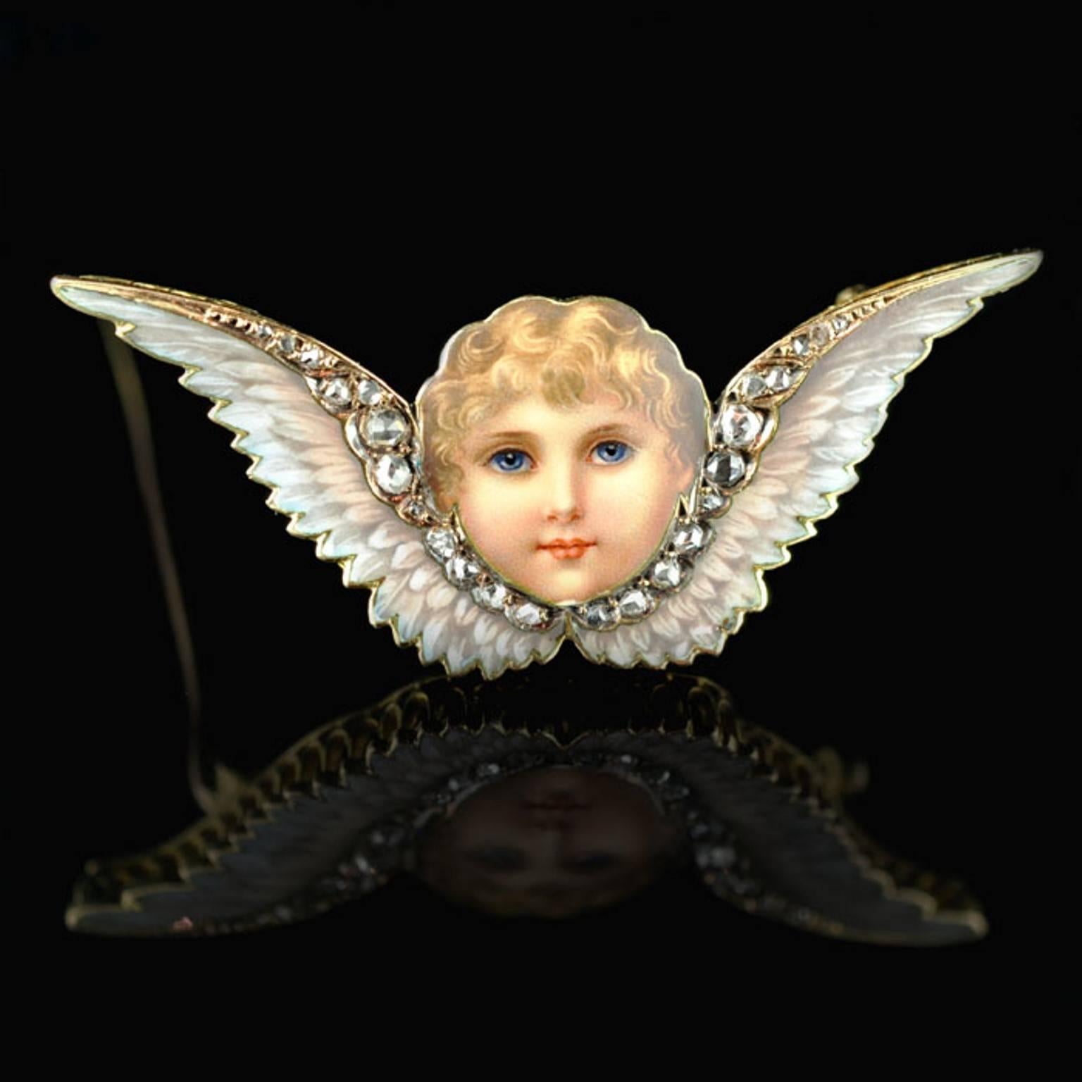 Beautiful brooch designed as the face of a cherub in polychrome enamel in between a pair of wings with diamond highlights.

Victorian circa 1885

English

24 old rose-cut diamonds 0.40cts approx

Yellow gold

6.4 grams

4.30cm /