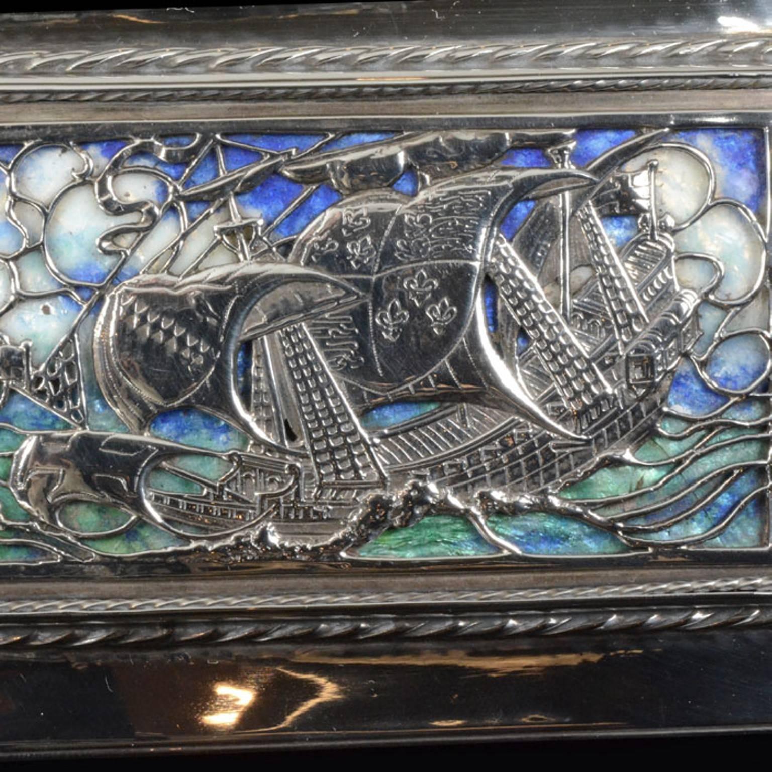 Rectangular silver box with applied twisted rope decoration bordering an enamel galleon at sea, the interior is wood lined, the base inscribed OMAR RAMSDEN ME FECIT

length 13.2cm  x 9.5cm wide

