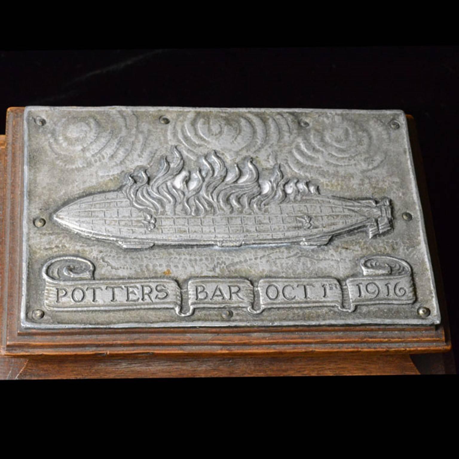 Rectangular form, the metal is from the zeppelin, the oak is from the tree the zeppelin hit commemorating the Potters Bar zeppelin disaster of October 1916

Omar Ramsden & Alwyn Carr

Length 12cm

1072 grams
