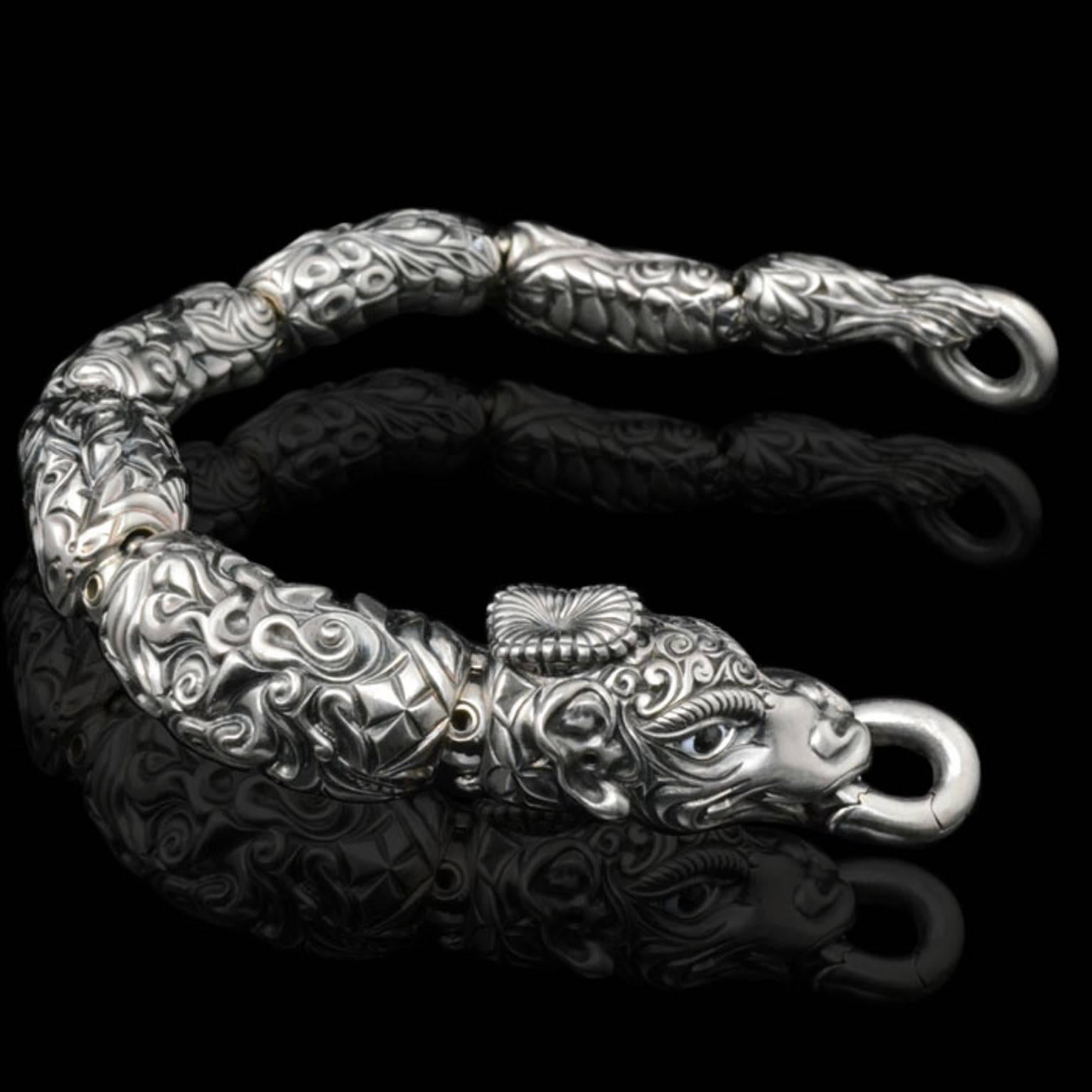 White gold bracelet designed as a dragon, with oxidized highlights and enamel eyes & teeth, Otto Jakob, 2012

18ct white gold - 1 of 6 made

132.50 grams

19cms/ 7.5