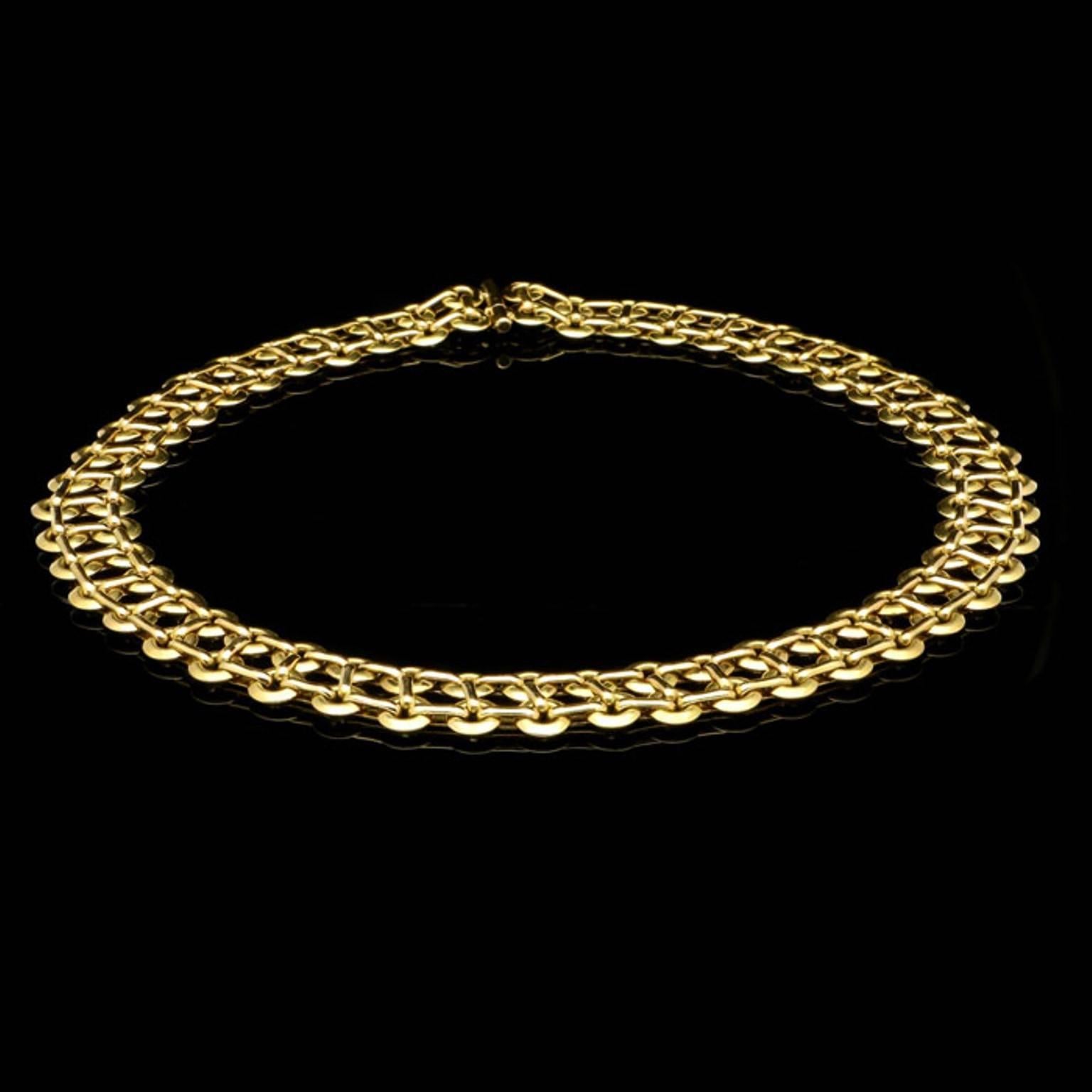 A gold double row circlet link necklace by Georges Lenfant, c.1960s, the highly articulated necklace in 18ct yellow gold designed as two rows of small open circlets joined together by three oval links forming a continuous very flexible piece with a