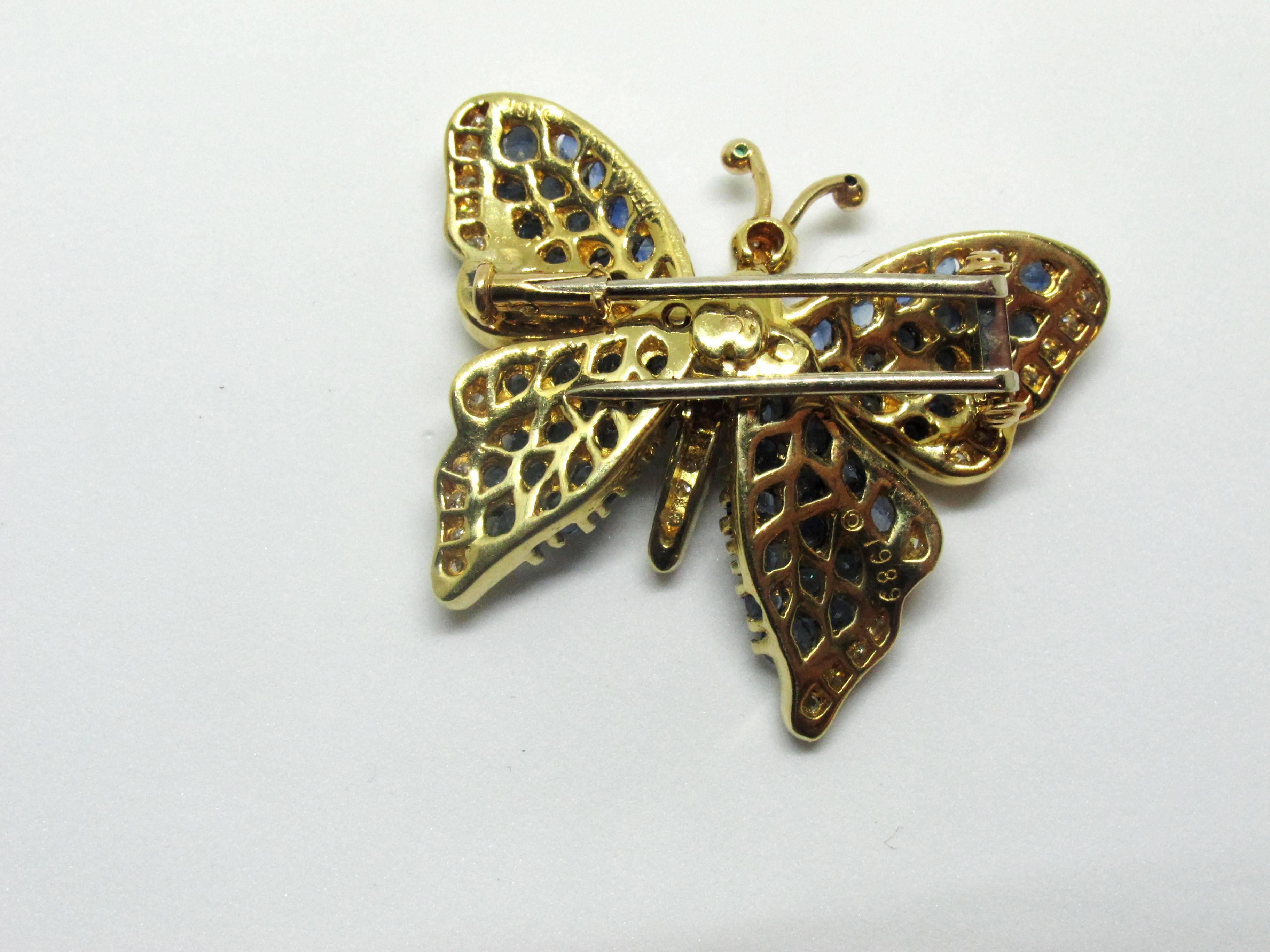 A Tiffany & Co. 18K yellow gold butterfly pin set with diamonds and blue sapphires. The reverse stamped Tiffany & Co 1989.