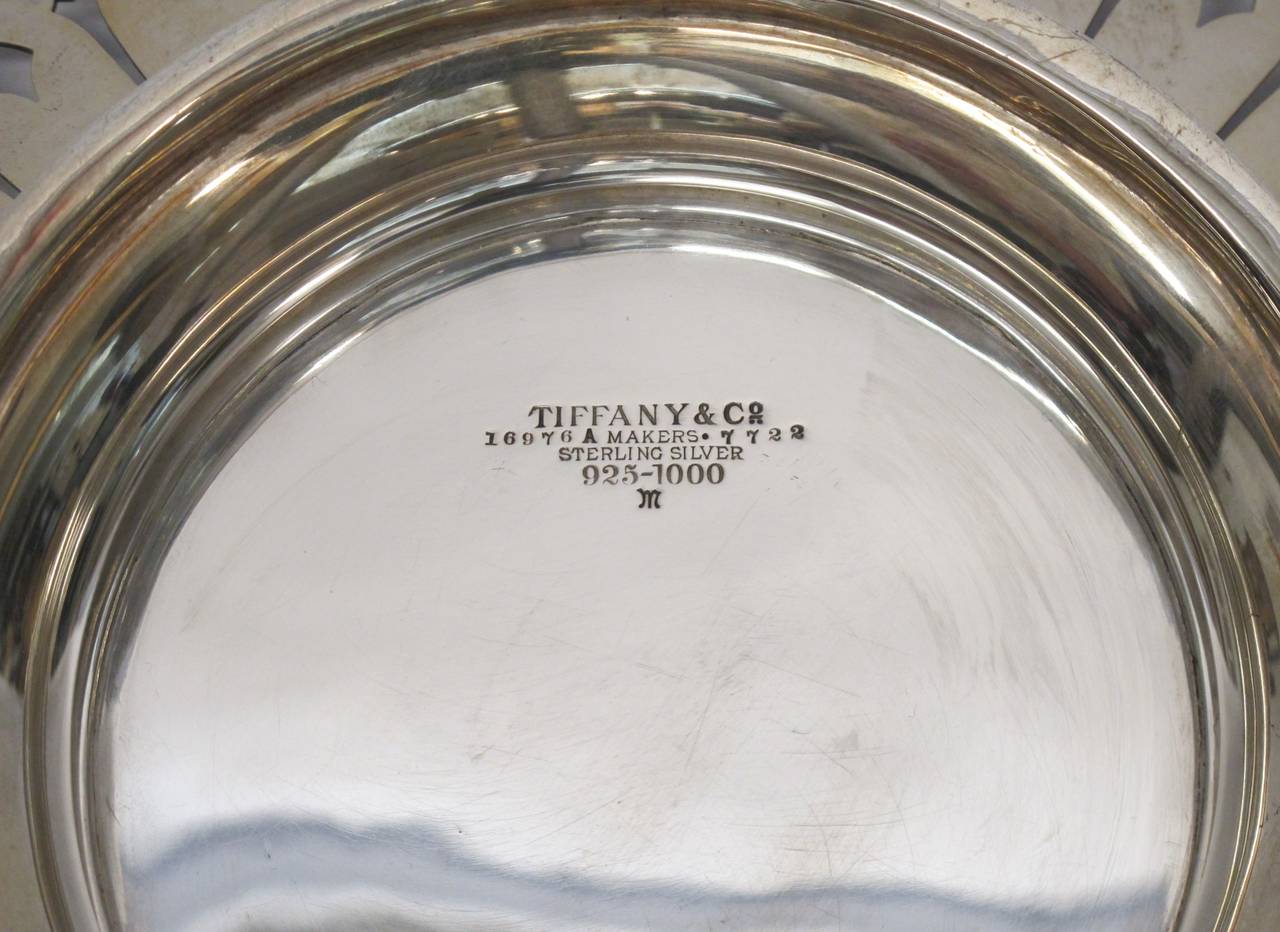 Stunning signed Tiffany & Co. pierced and engraved sterling silver footed tray. This piece dates 1907-1947. It is in excellent condition with an entwined cipher monogram on the top center.